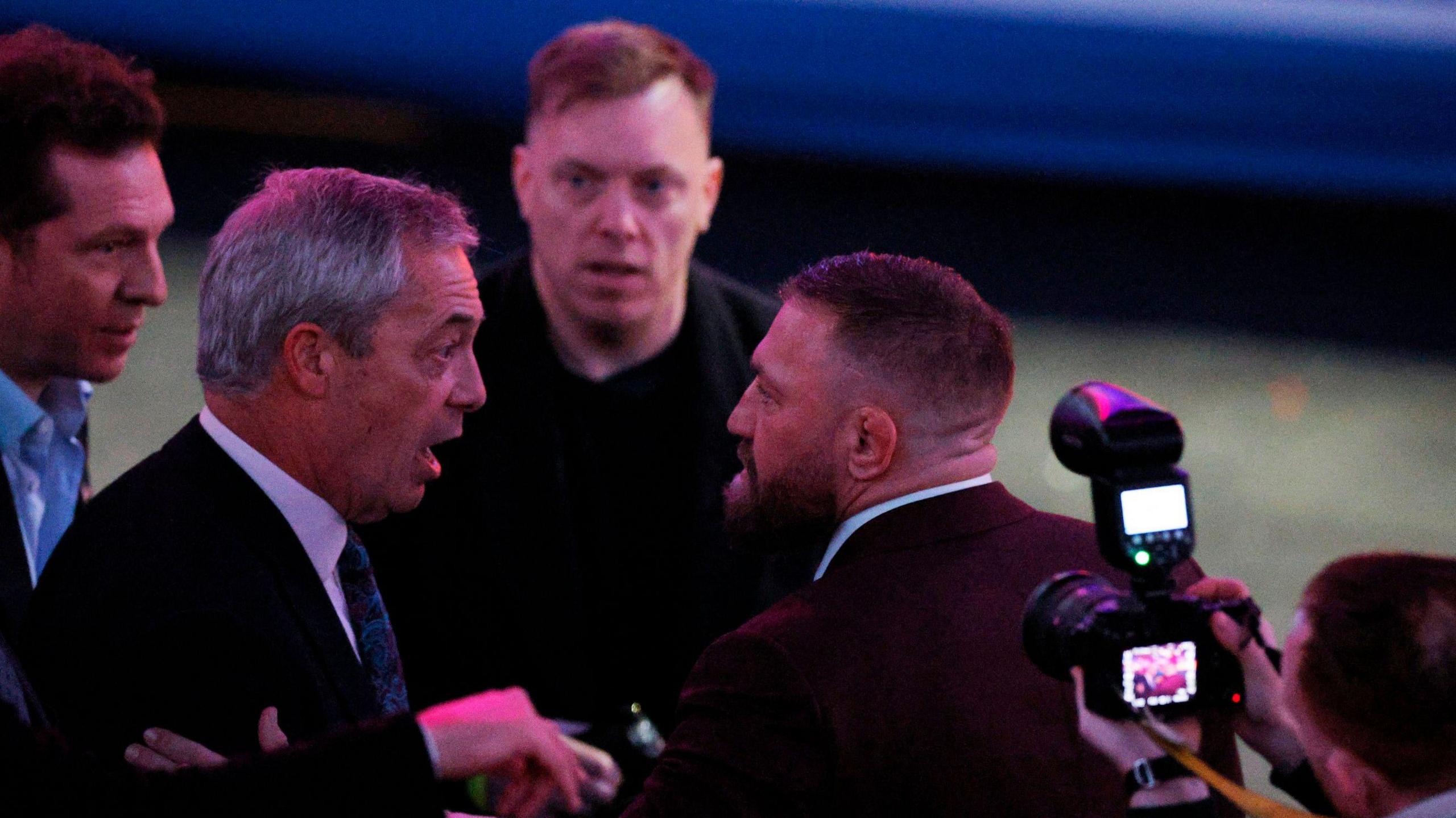 British politician Nigel Farage and Irish MMA fighter Conor McGregor chatting at a Trump rally on Sunday  