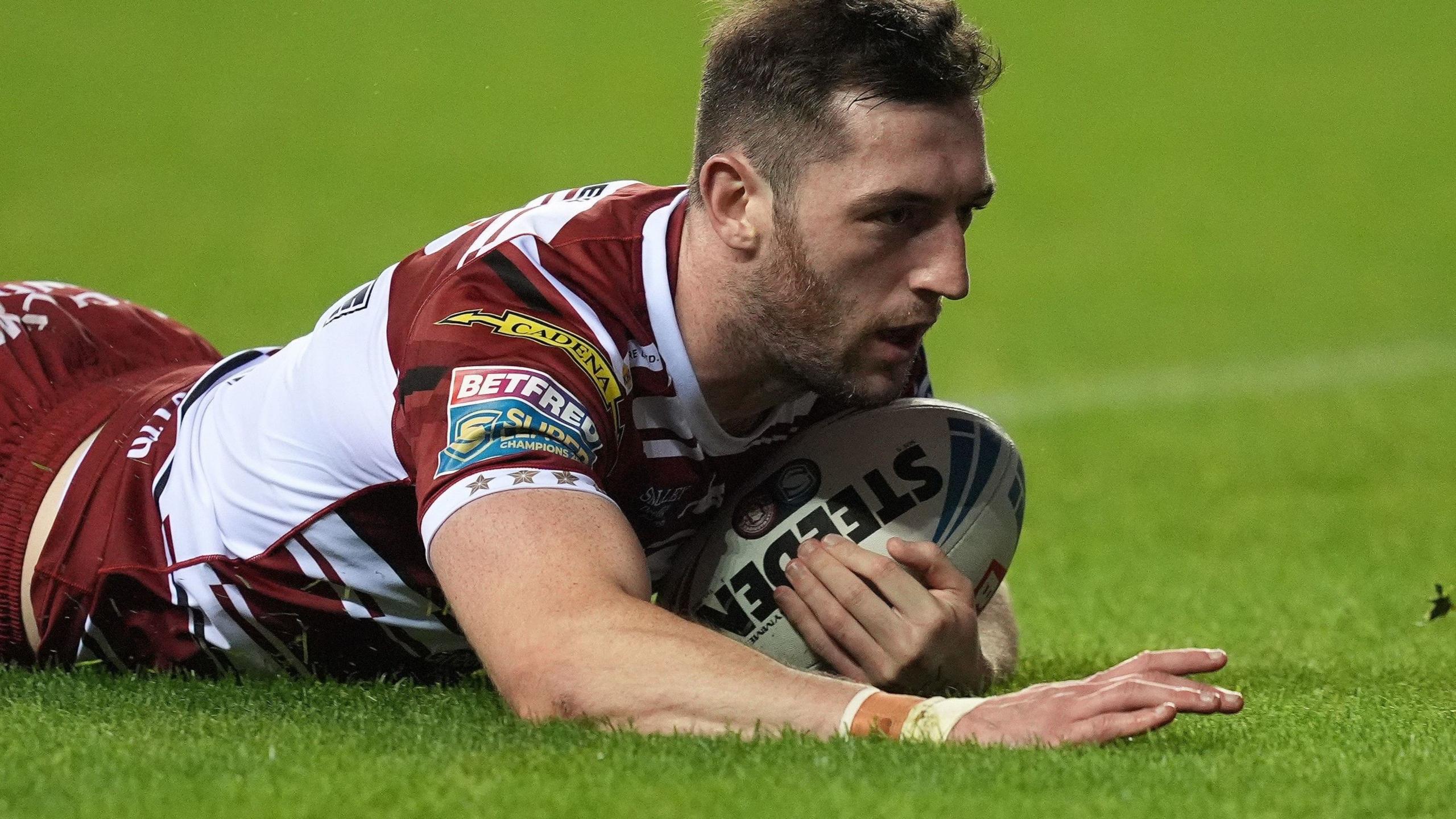 Jake Wardle dives to score a try for Wigan Warriors