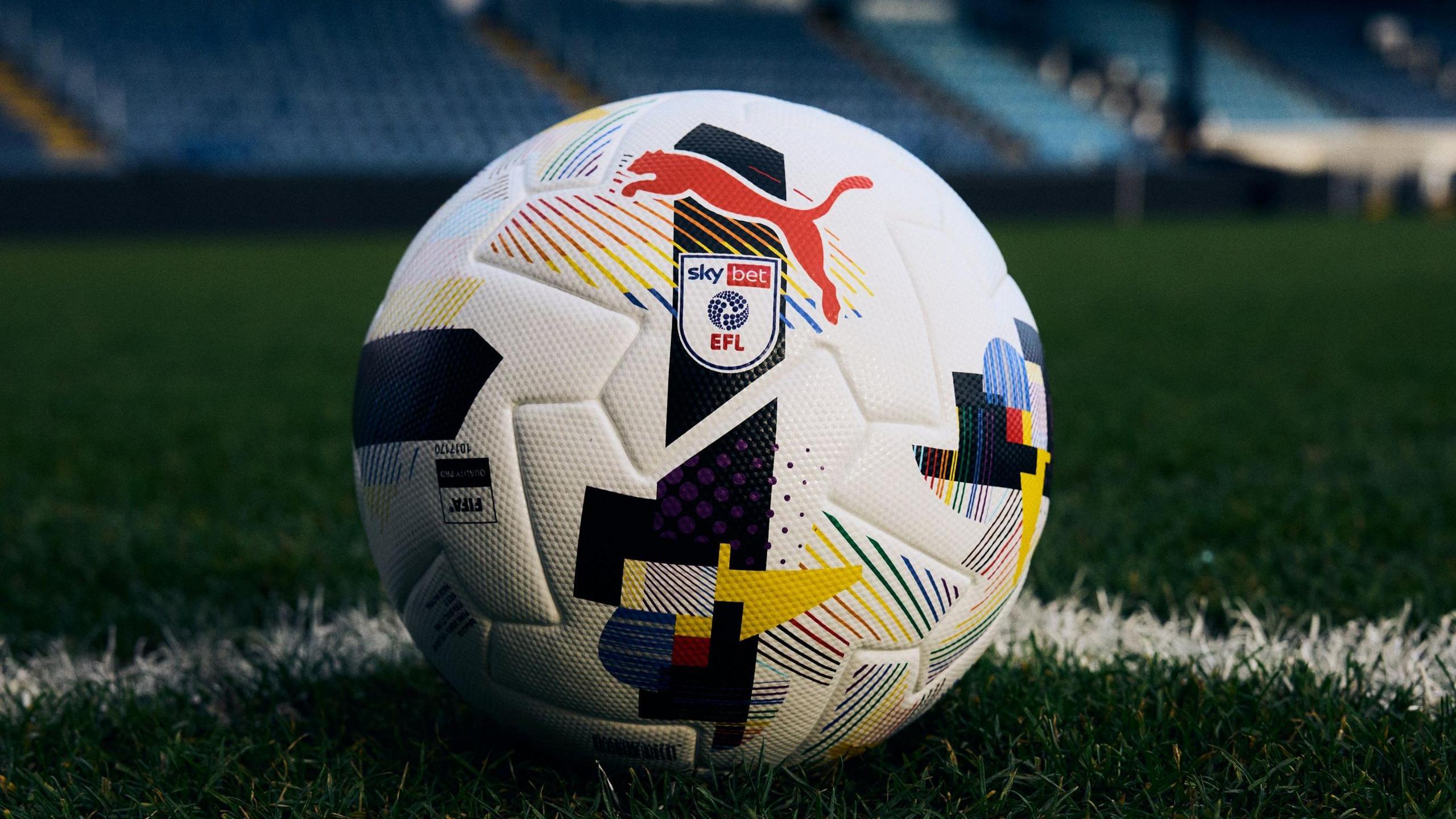 A close up of Puma's rainbow ball that features a selection of colourful geometrical shapes on a traditional white background