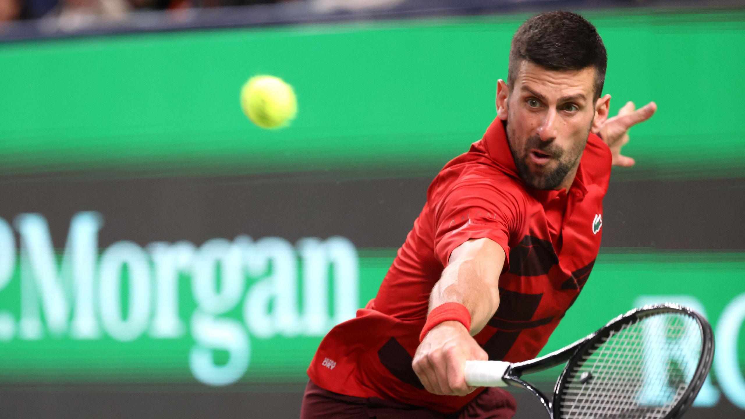 Novak Djokovic hits a return during his Shanghai Masters match against Flavio Cobolli