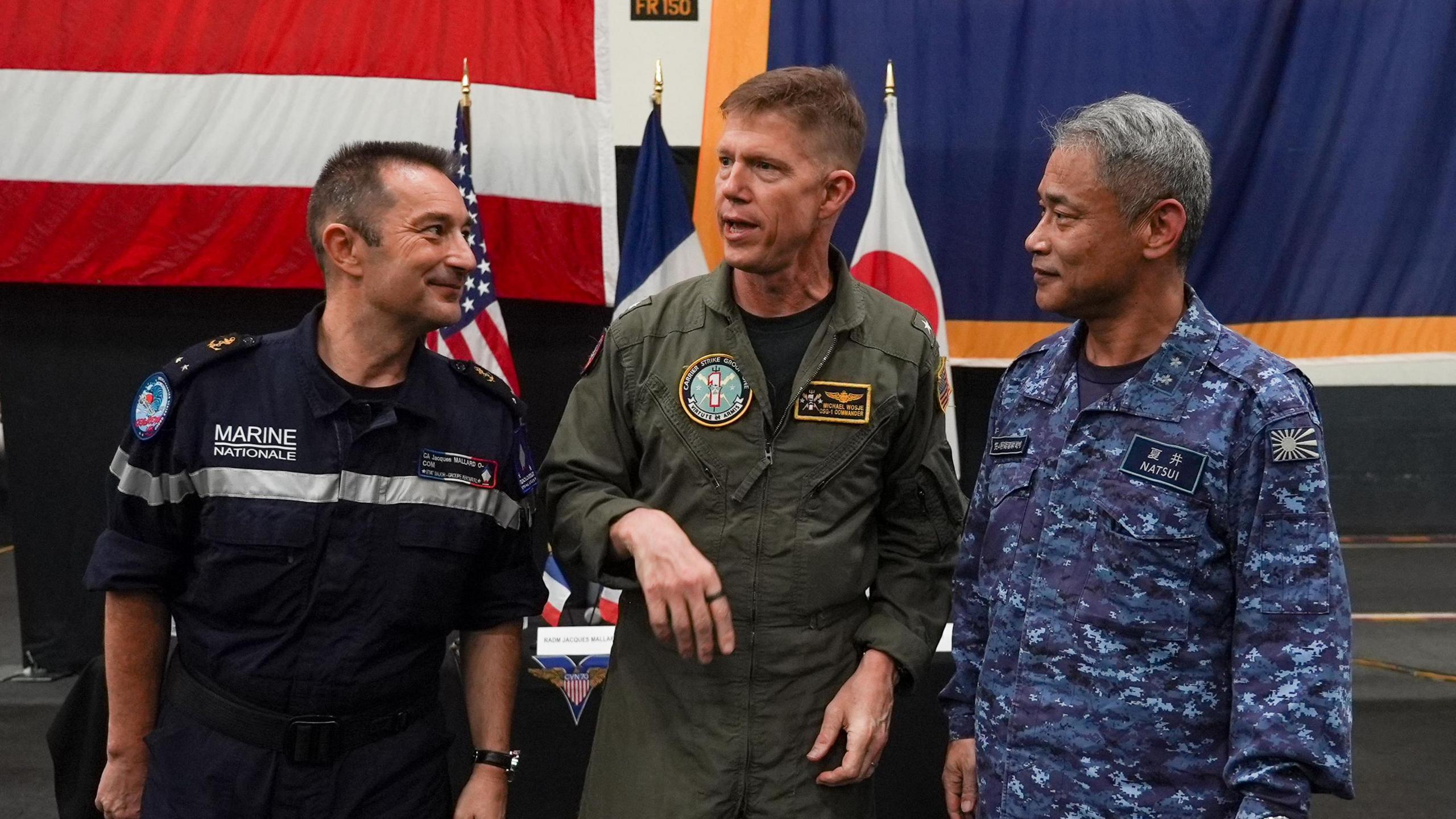 From left: Rear Admiral Jacques Mallard, Rear Admiral Michael Wosje and Rear Admiral Natsui Takashi standing together on Carl Vinson