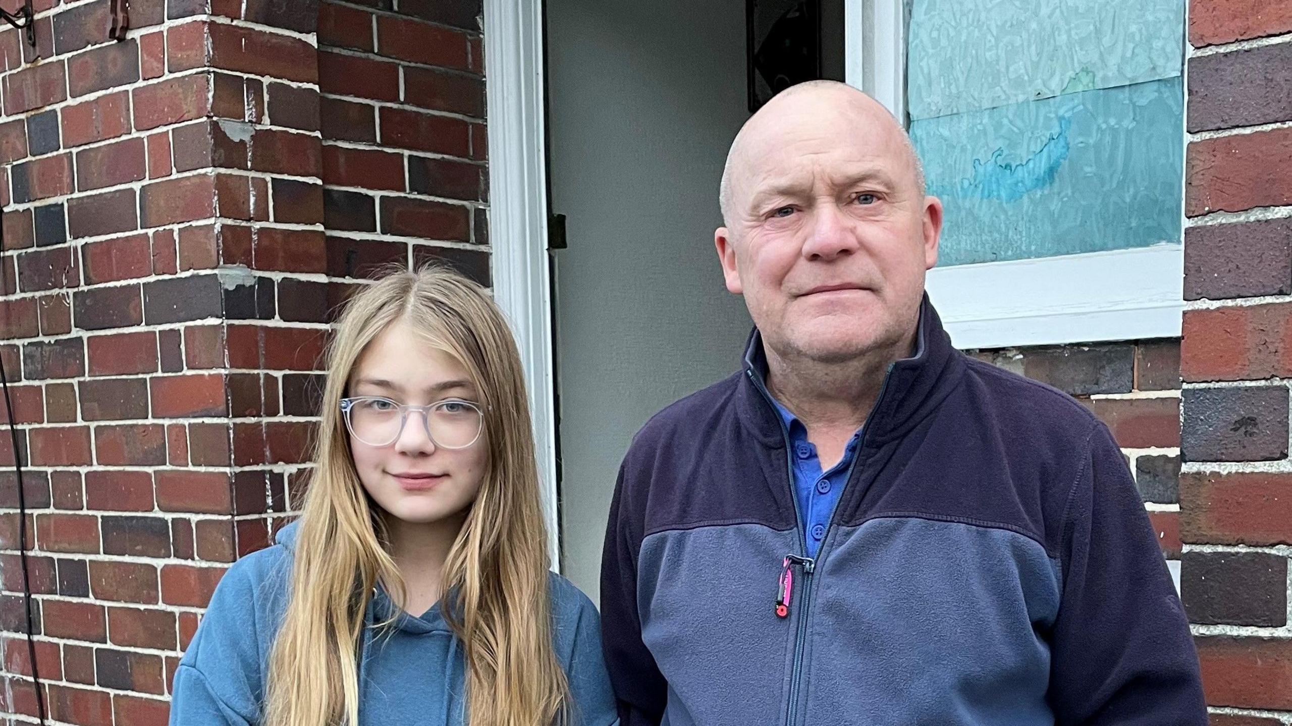 Alan and Emily outside their front door