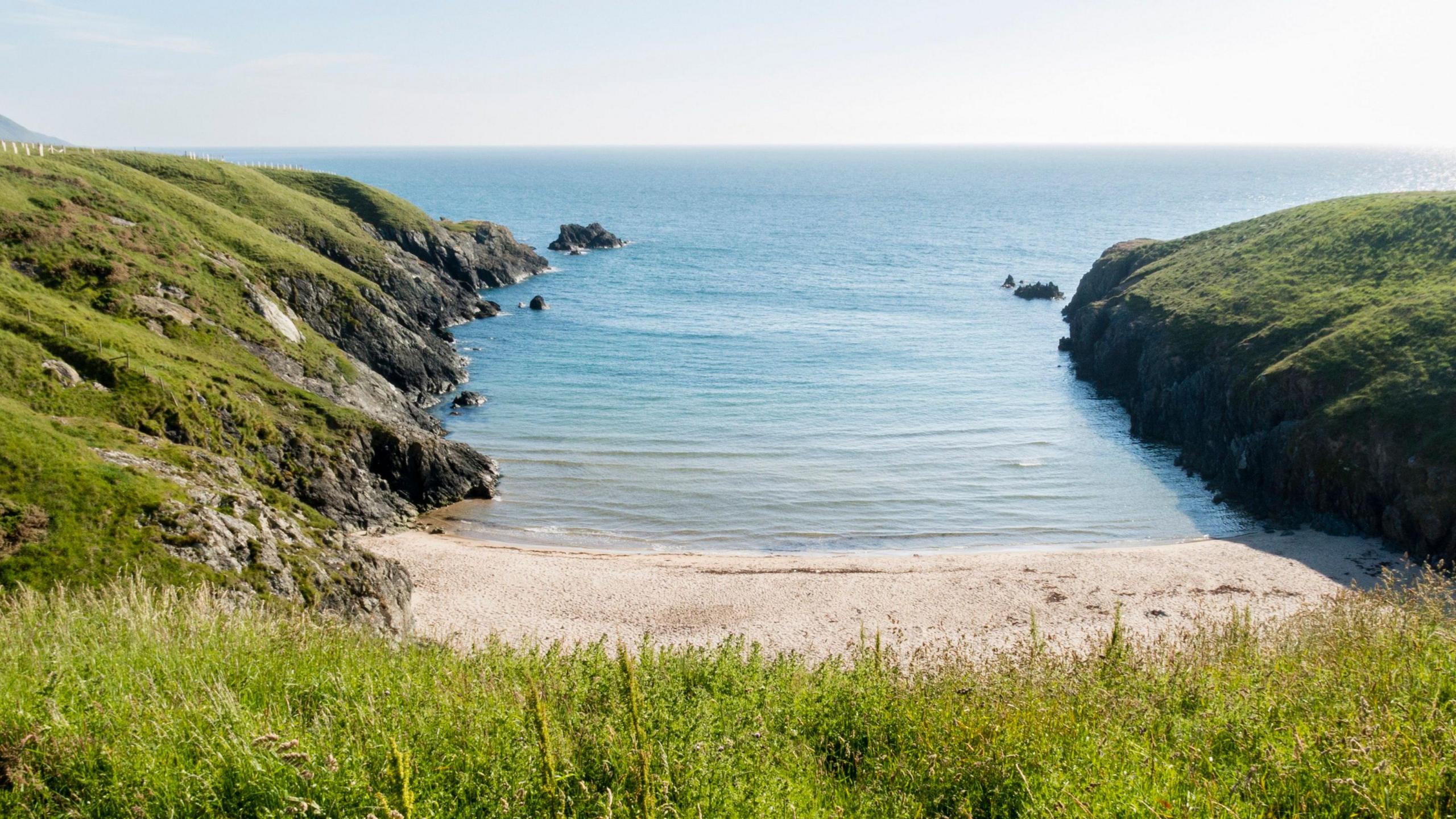 A view of the secluded beach at Porth Iago