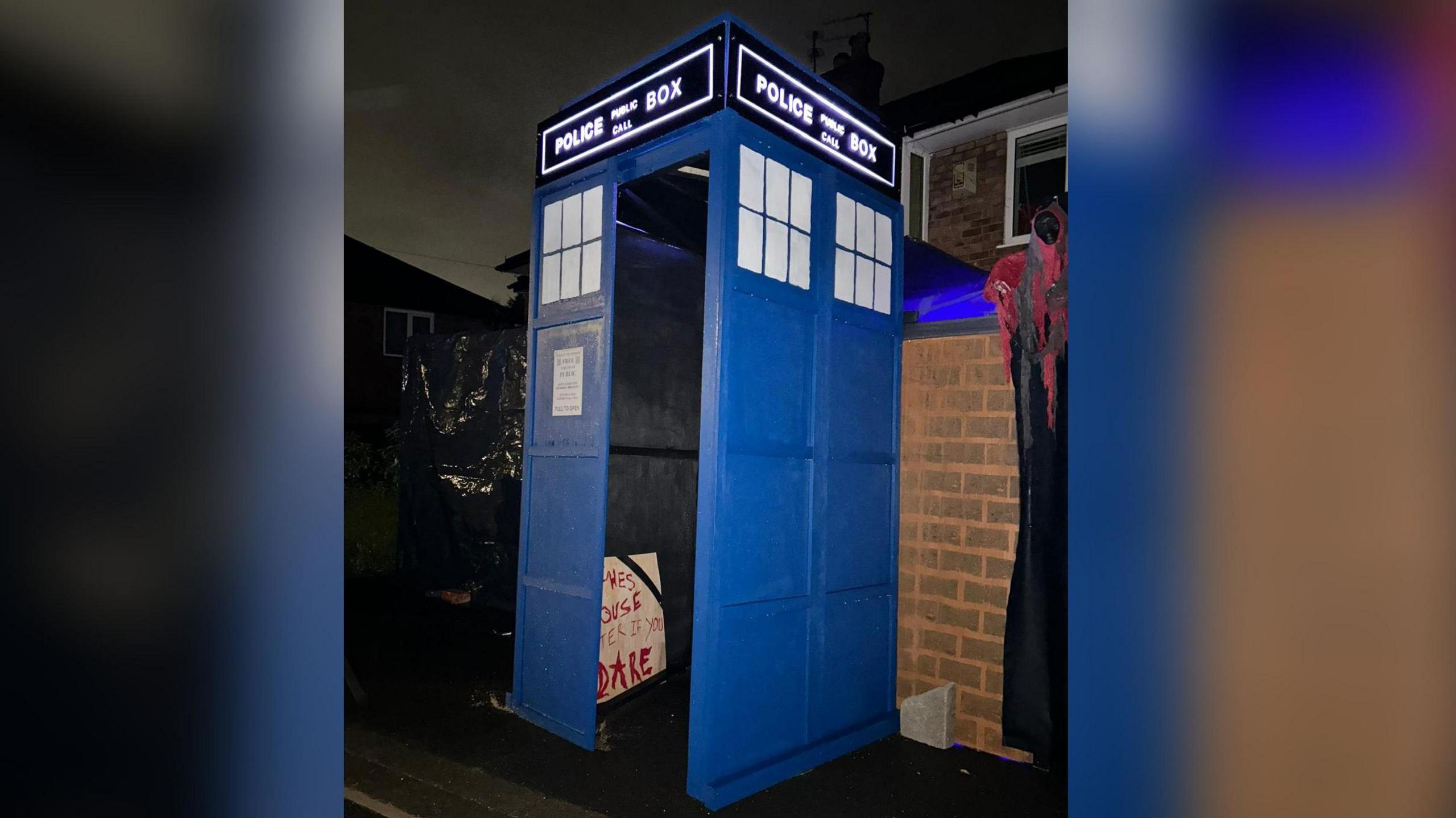 A large-scale model of a Tardis with a sign inside saying something like 'enter this house if you dare' in red scrawed writing.