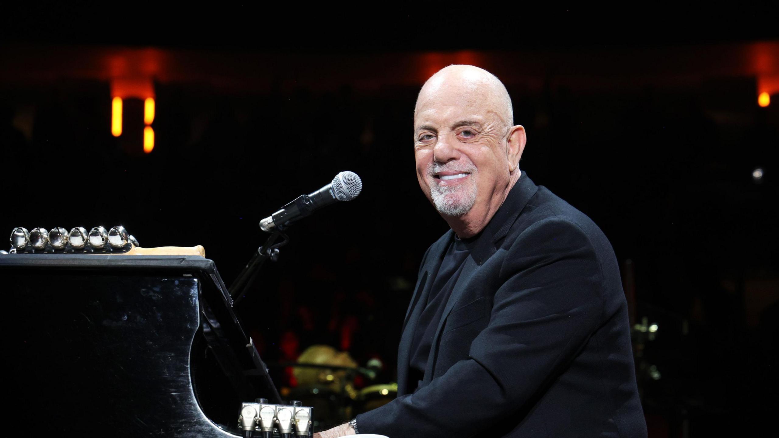 Billy Joel performing at his piano