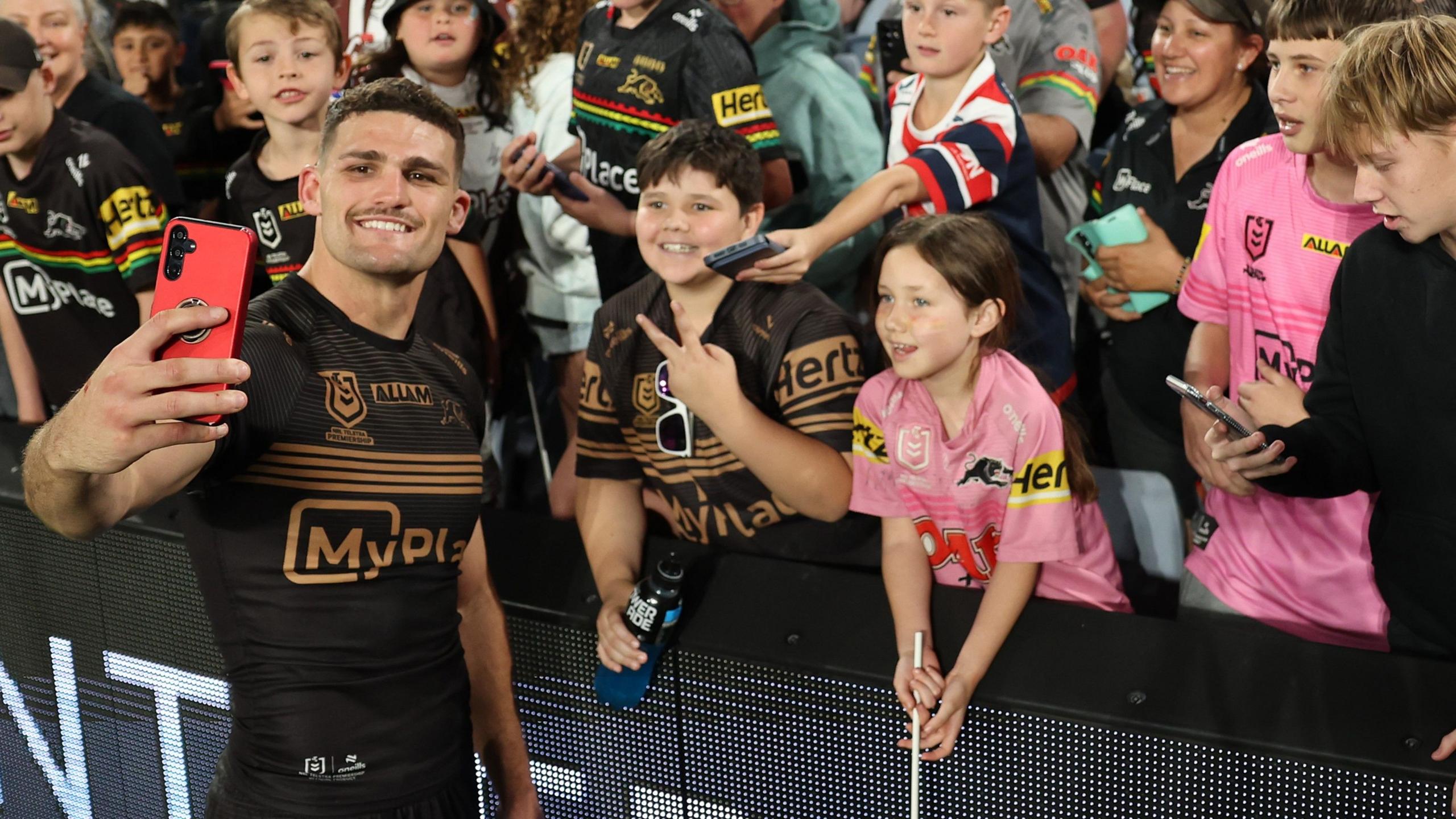 Nathan Cleary poses for a selfie with young Penrith Panthers fans