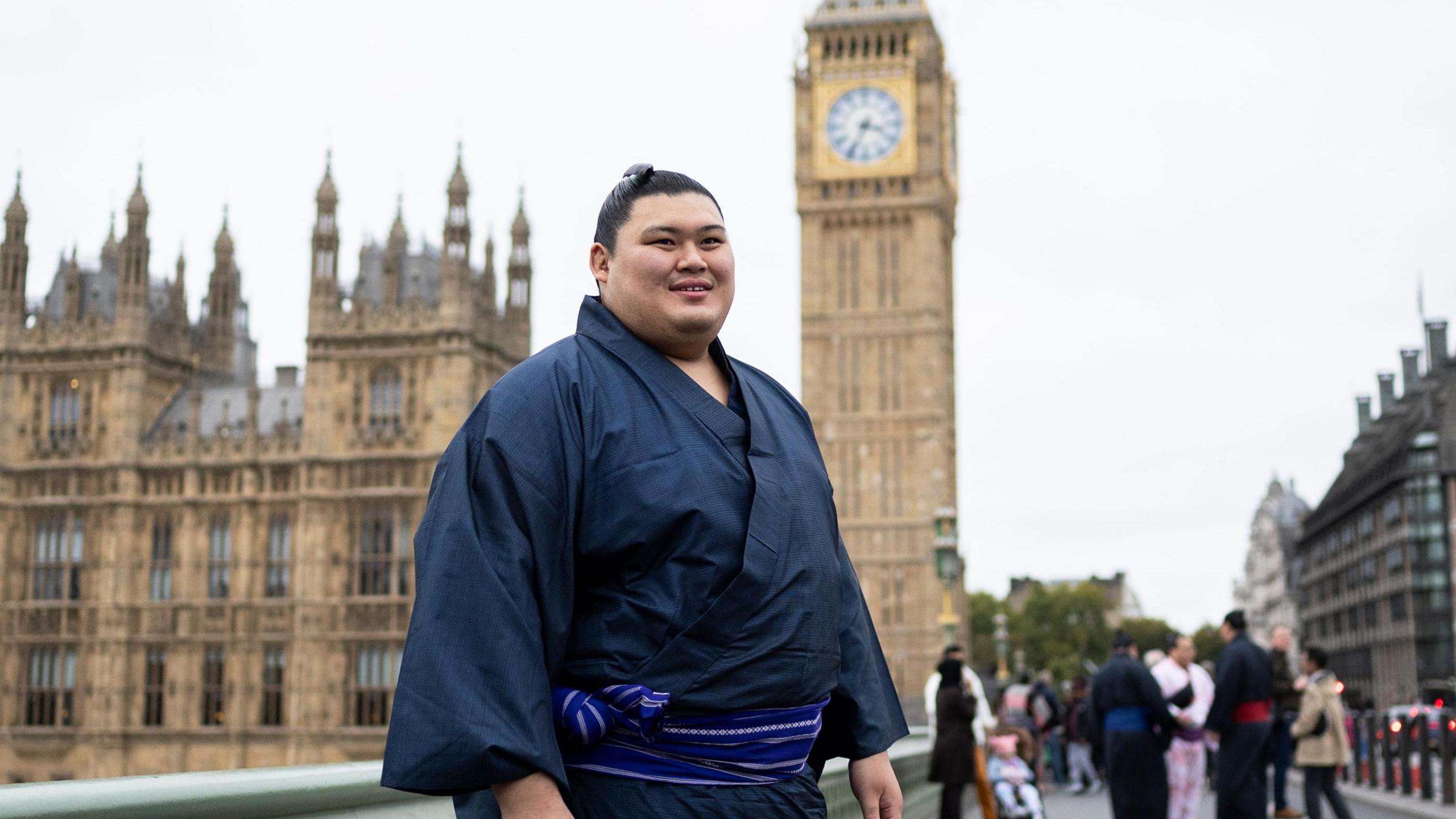 Yokozuna Onosato walks near the Houses of Parliament during a tour of central London ahead of the tournament at the Royal Albert Hall