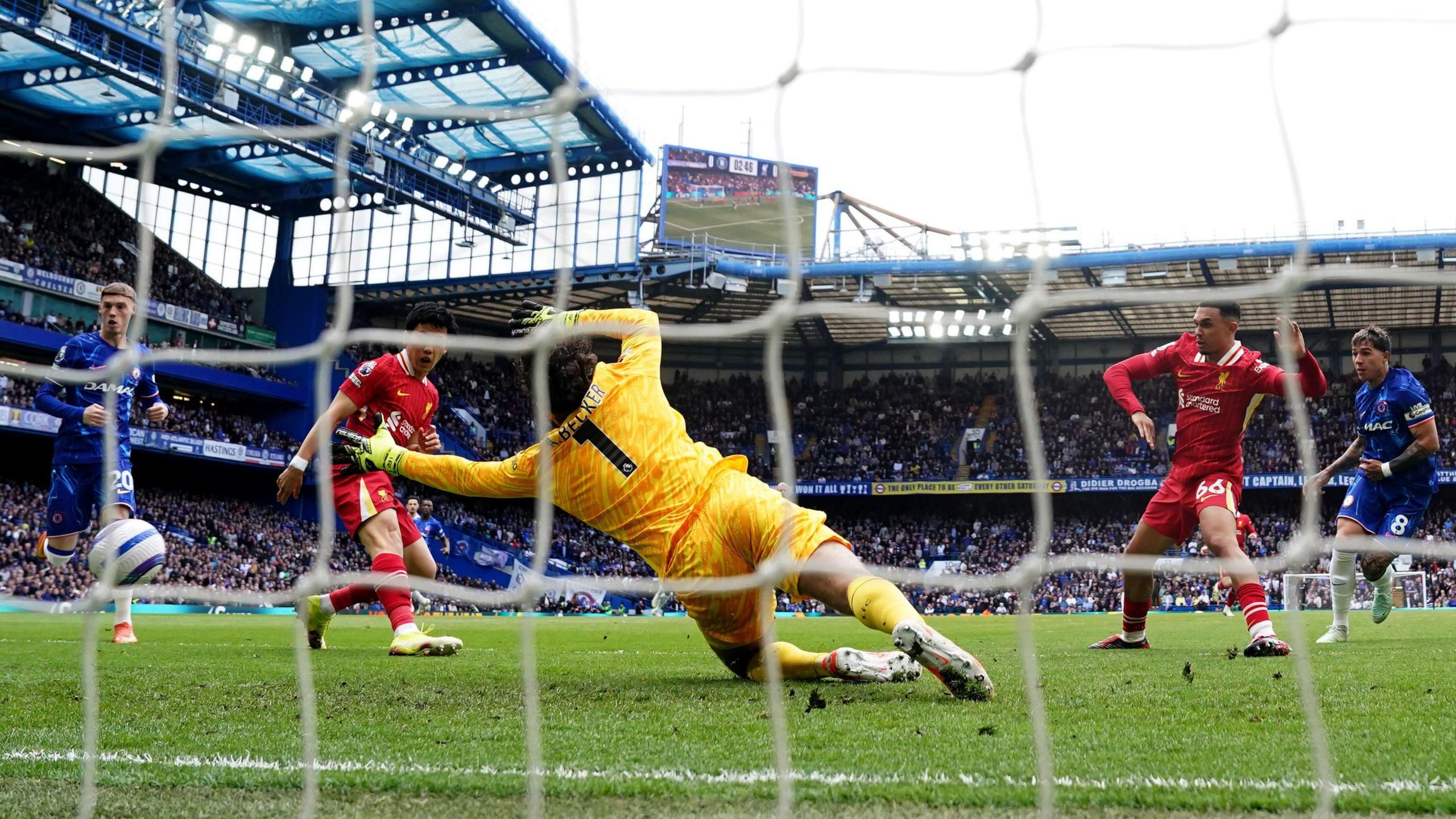 Enzo Fernandez (right) steers home Chelsea's first goal against Liverpool at Stamford Bridge