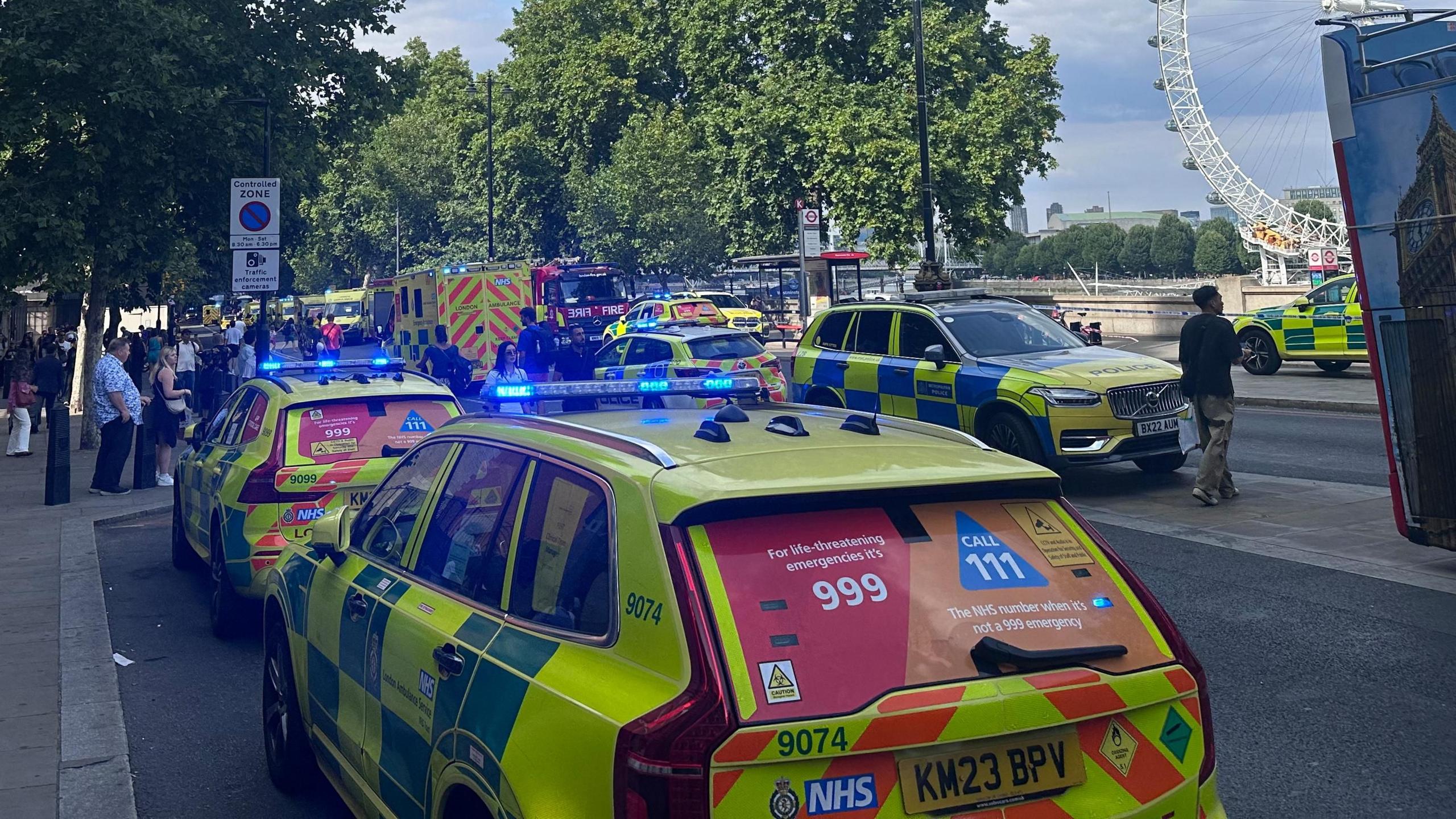 Emergency service vehicles parked with blue lights flashing