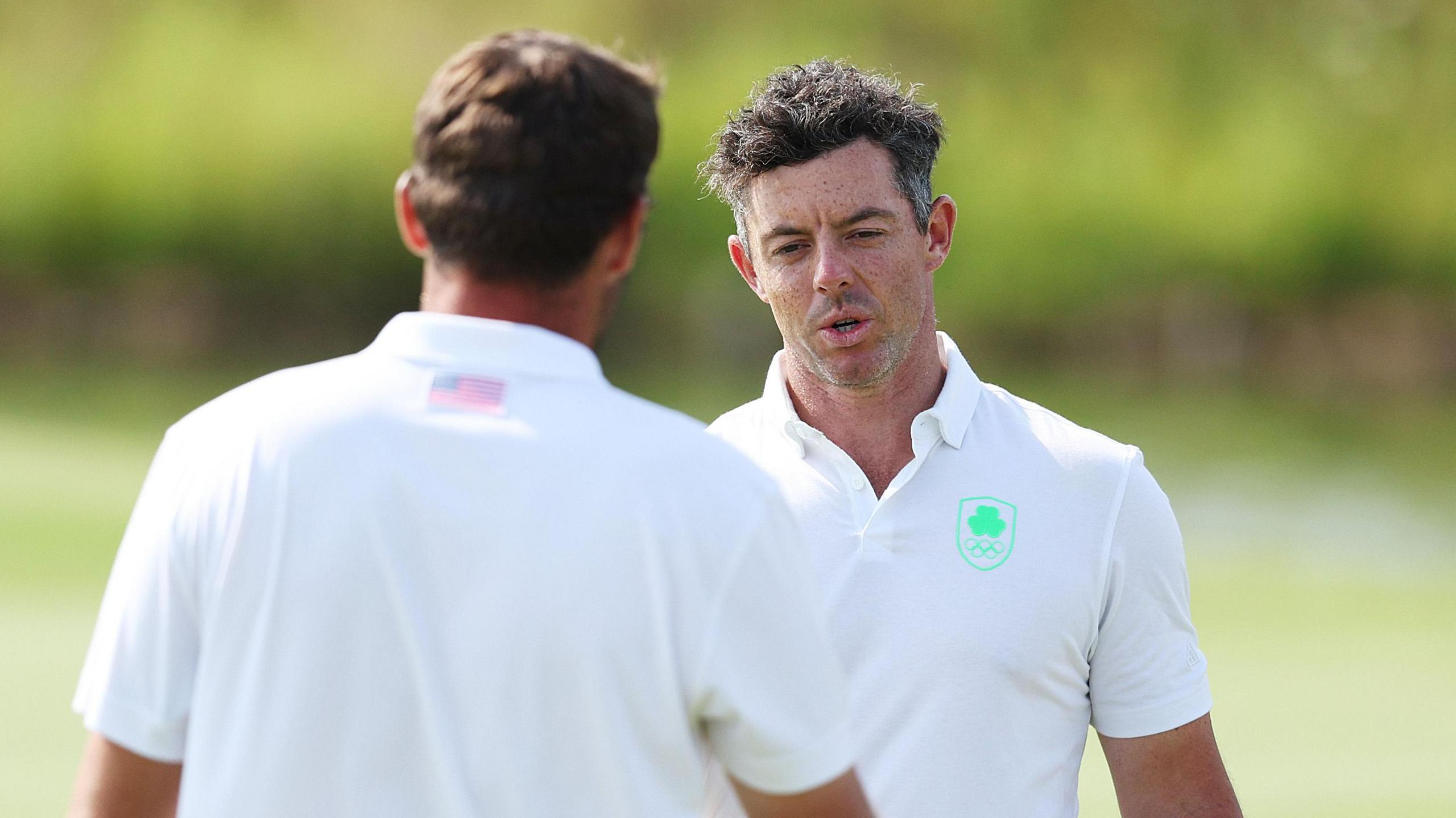 Rory McIlroy shakes Scottie Scheffler's hand at the conclusion of their second round