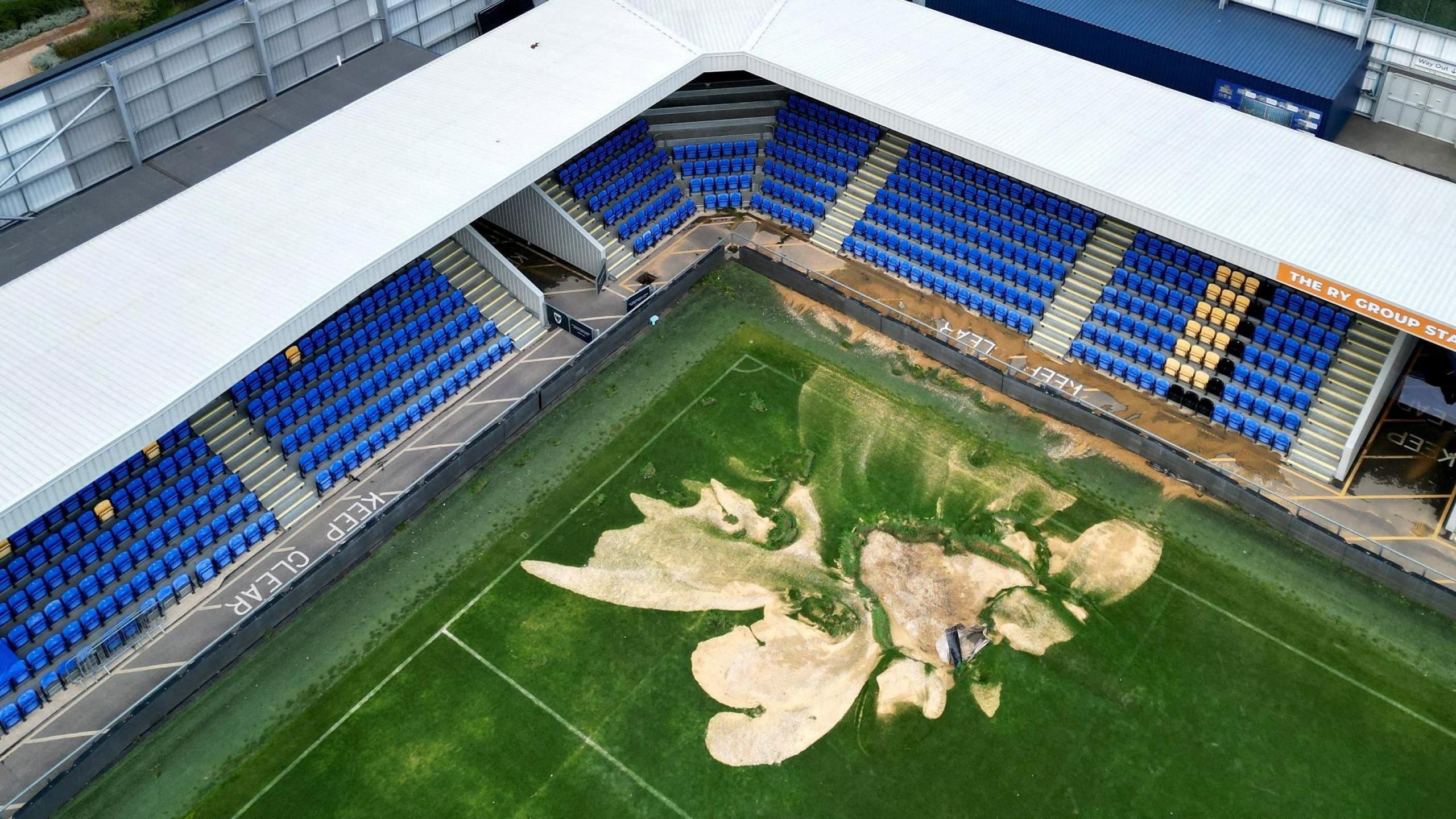 Flooding from the River Wandle has damaged a large area of the pitch at AFC Wimbledon's Plough Lane home