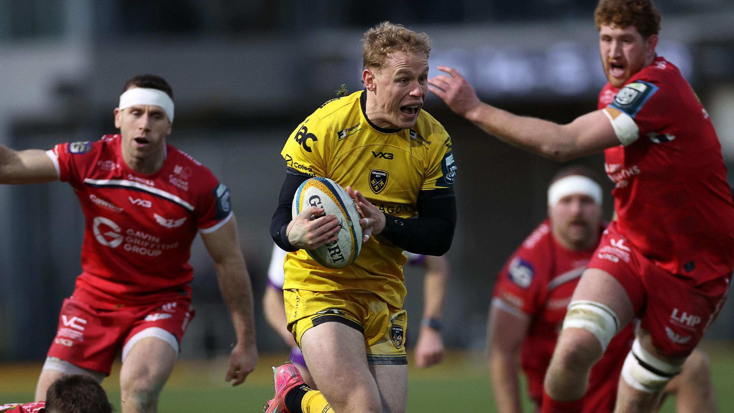 David Richards runs in to score a try for Dragons against Scarlets