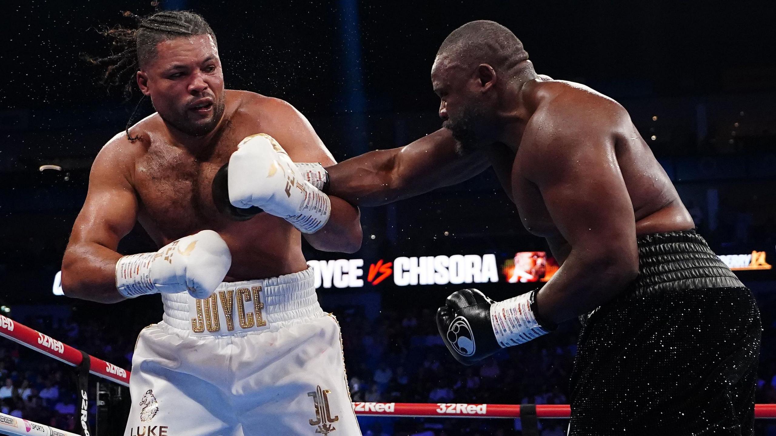 Derek Chisora throws a right hand at Joe Joyce