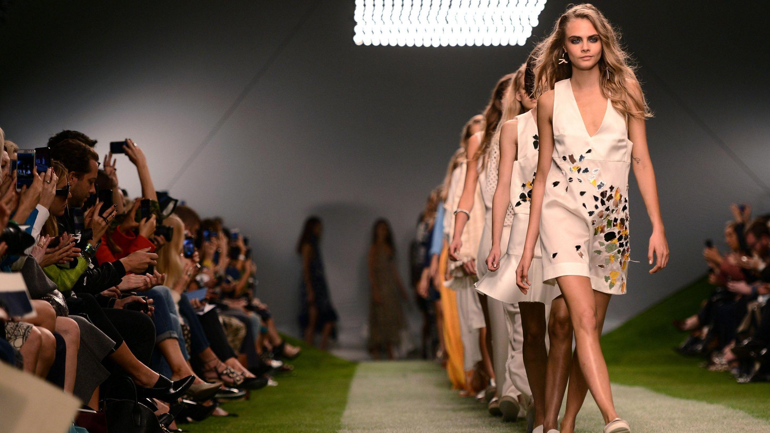 Cara Delevingne walks the runway of the Unique show during London Fashion Week SS14 at TopShop Show Space on September 15, 2013 in London, England.
