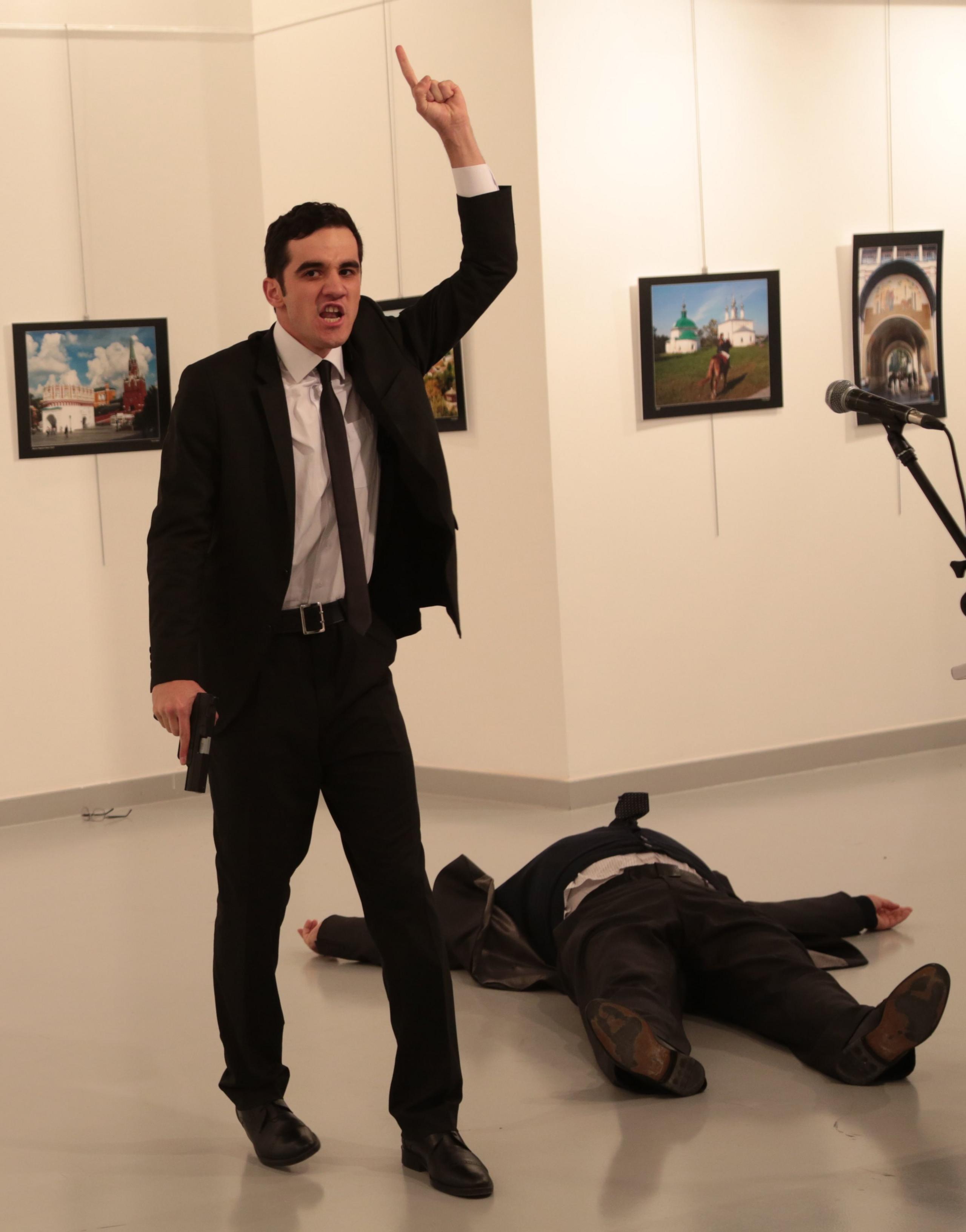 Mevlut Mert Altintas with a gun and Andrei Karlov's body beside him