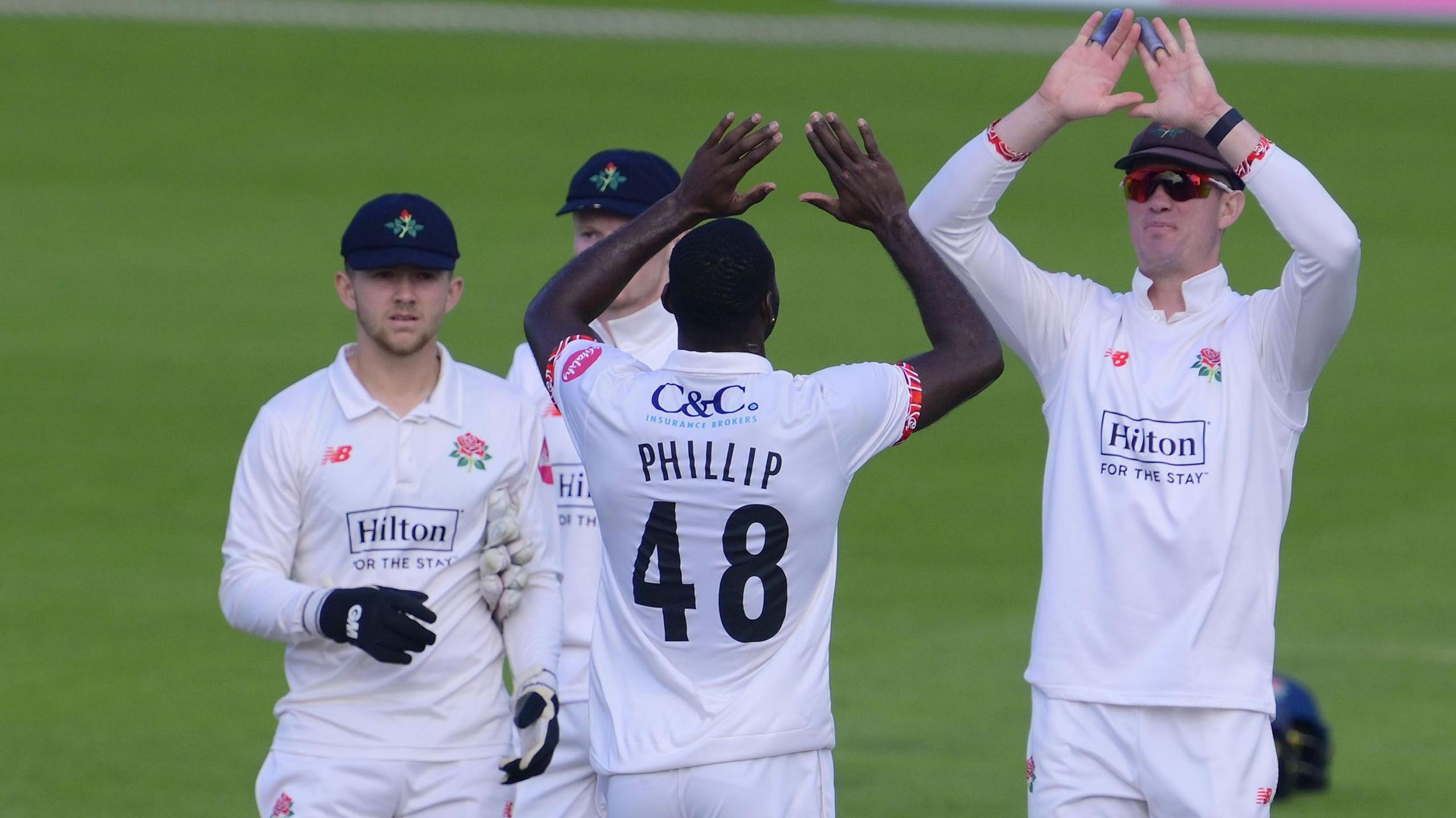 Anderson Phillip celebrates a wicket with Matty Hurst (left) and captain Keaton Jennings