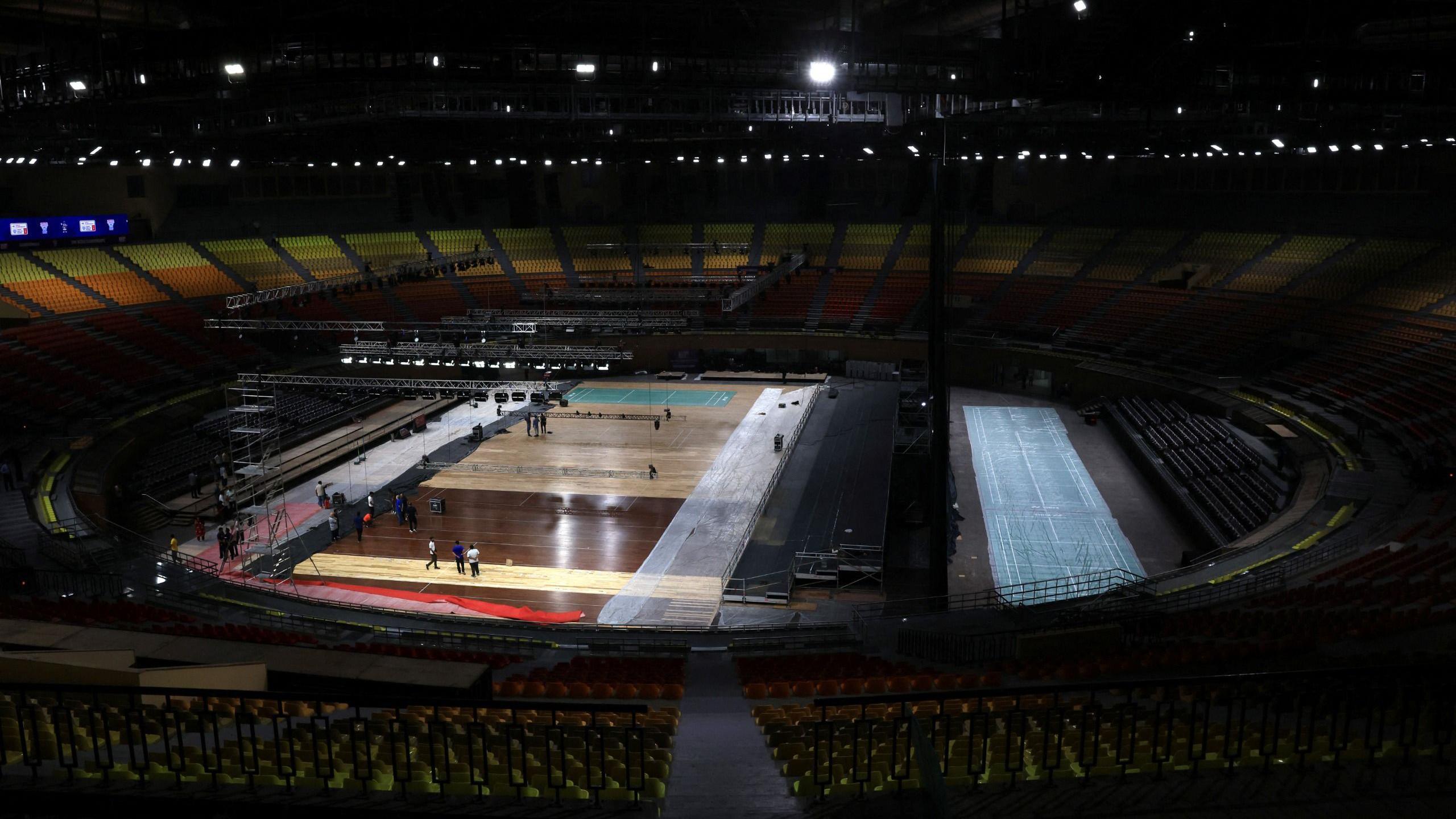 Workers prepare badminton courts for the upcoming BWF World Championships inside the Indira Gandhi Indoor Stadium in New Delhi, India, August 10, 2026. 