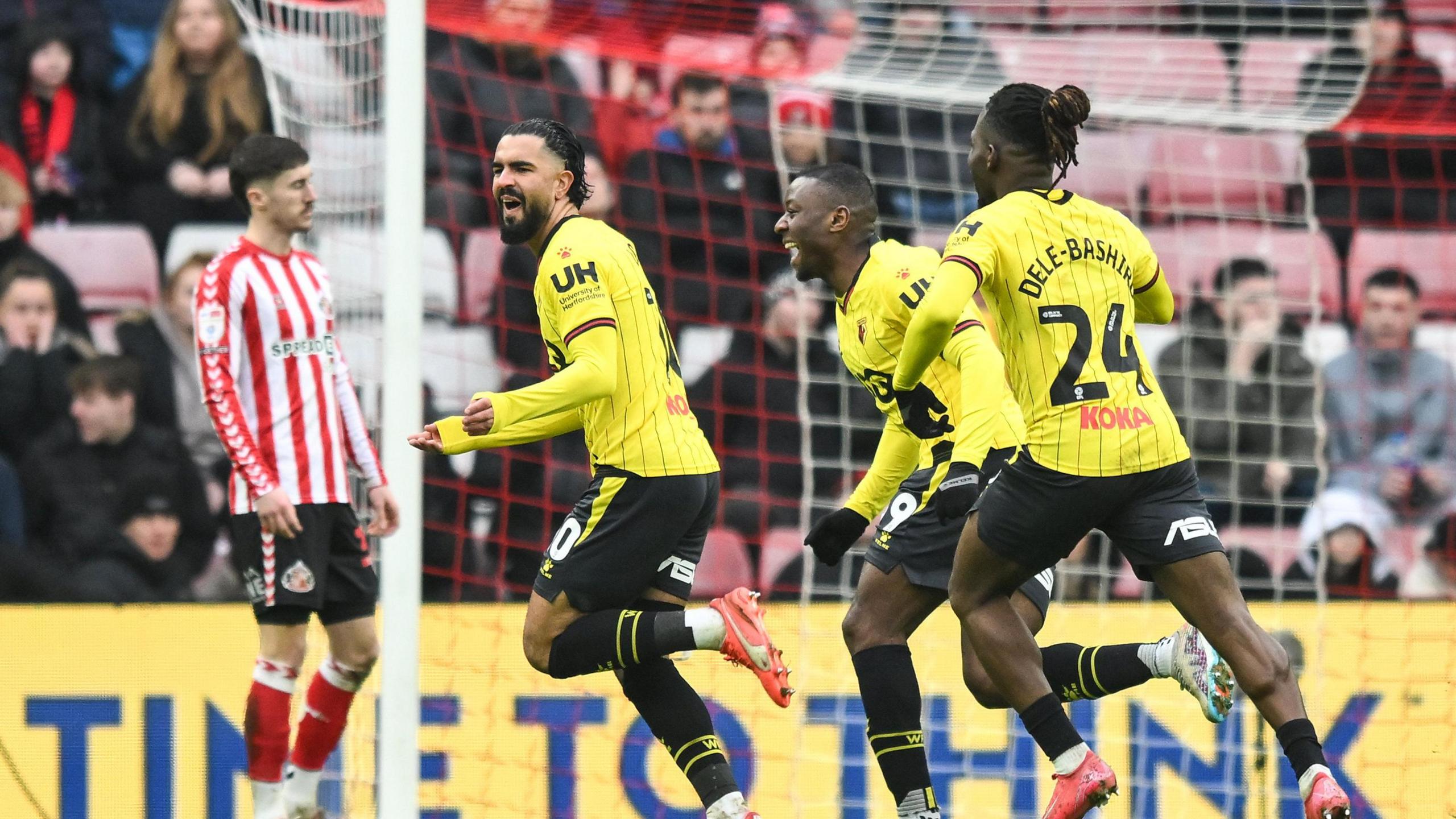 Imran Louza runs off after scoring his goal, followed by 2 team-mates 