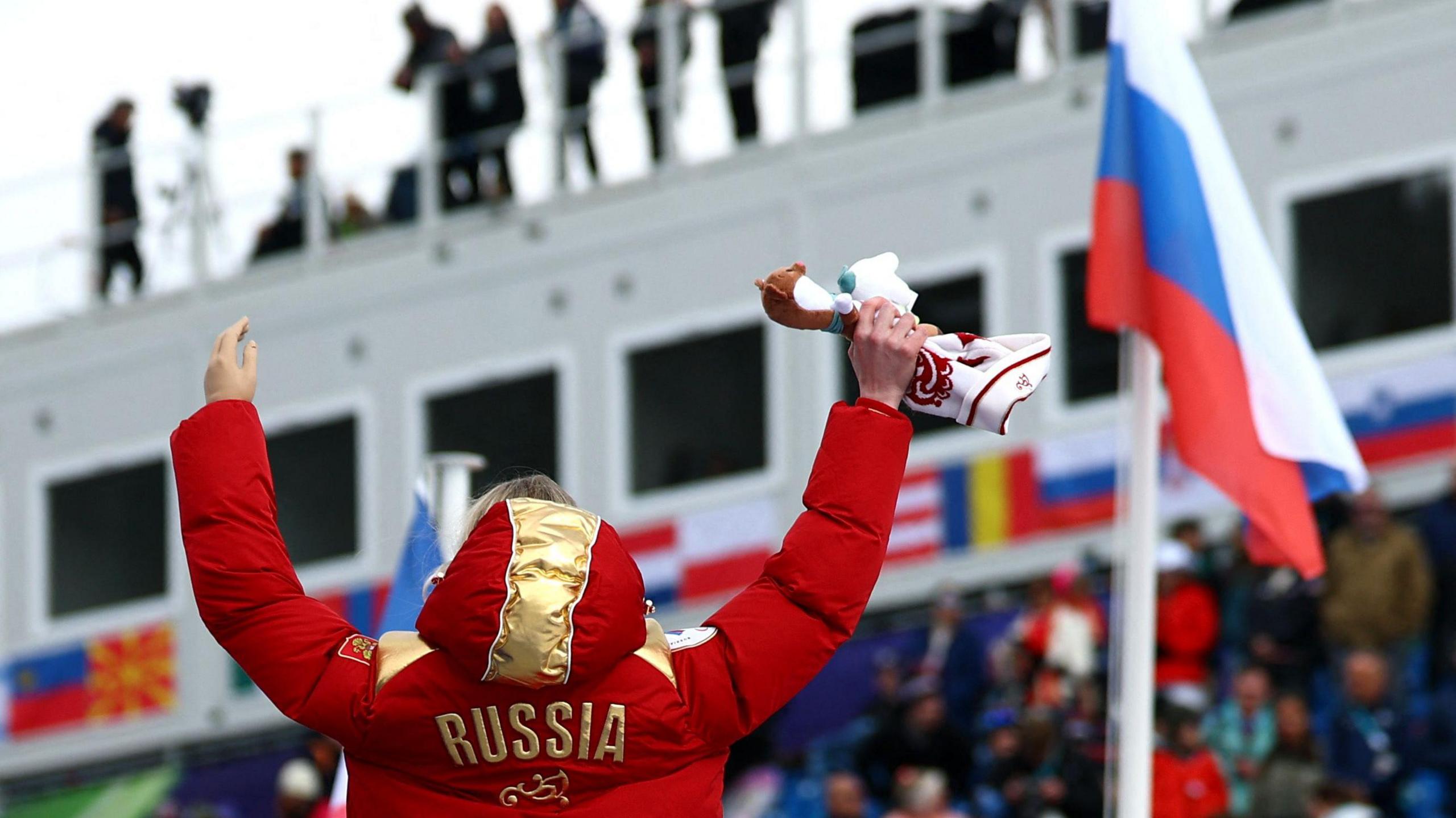 Varvara Voronchikhina celebrates on the podium as the Russian flag is raised 