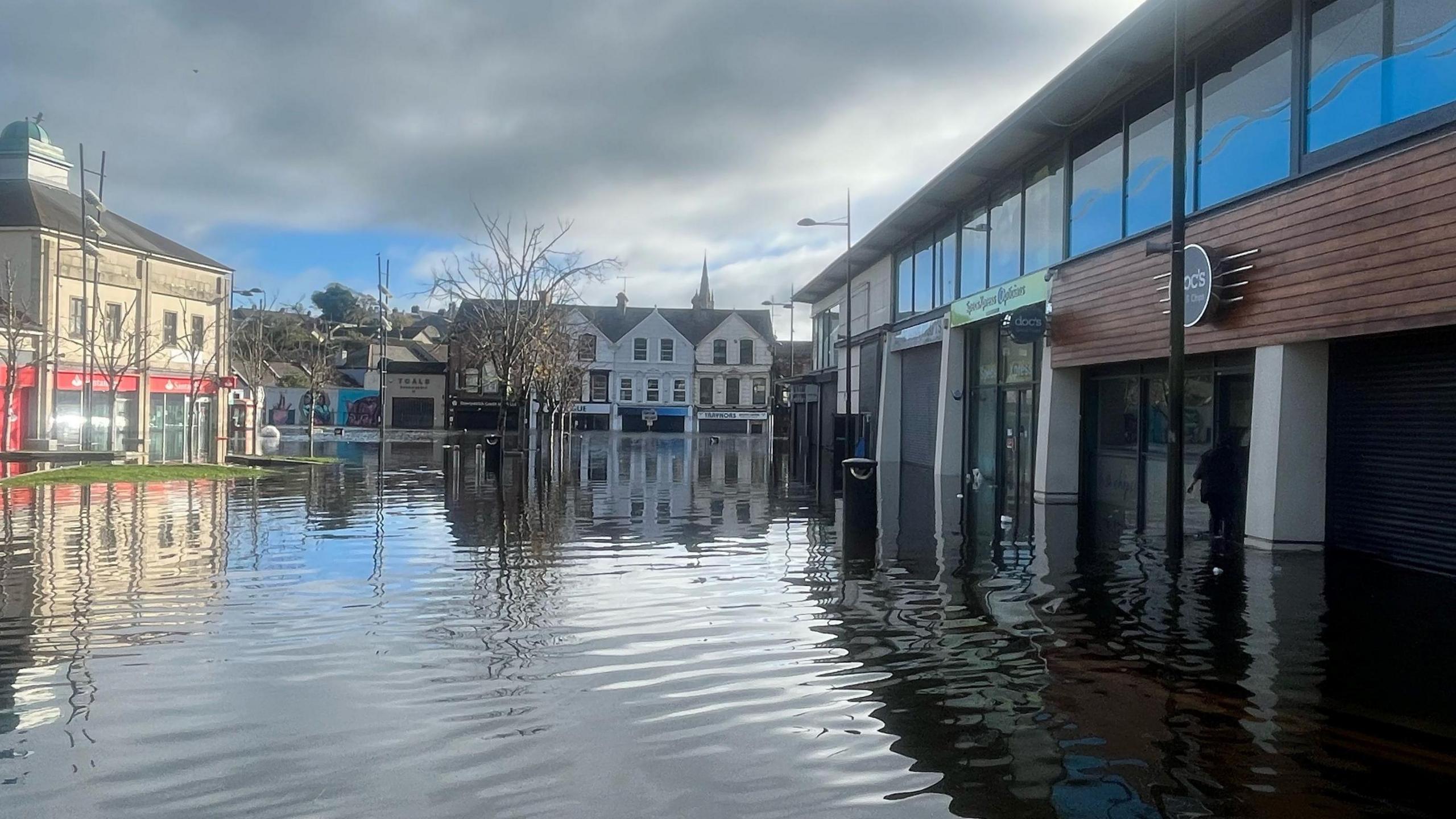 Water surrounding closed shops.