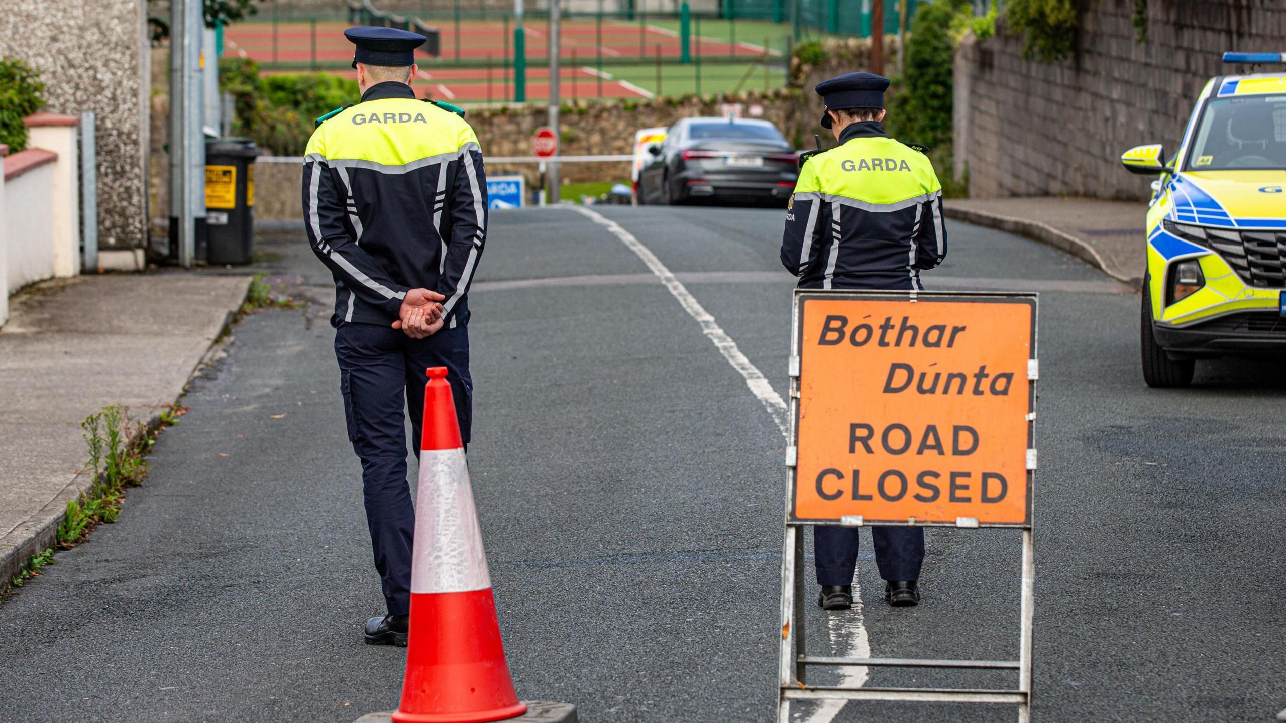 Gardaí stand outside the crash scene in Clonmel