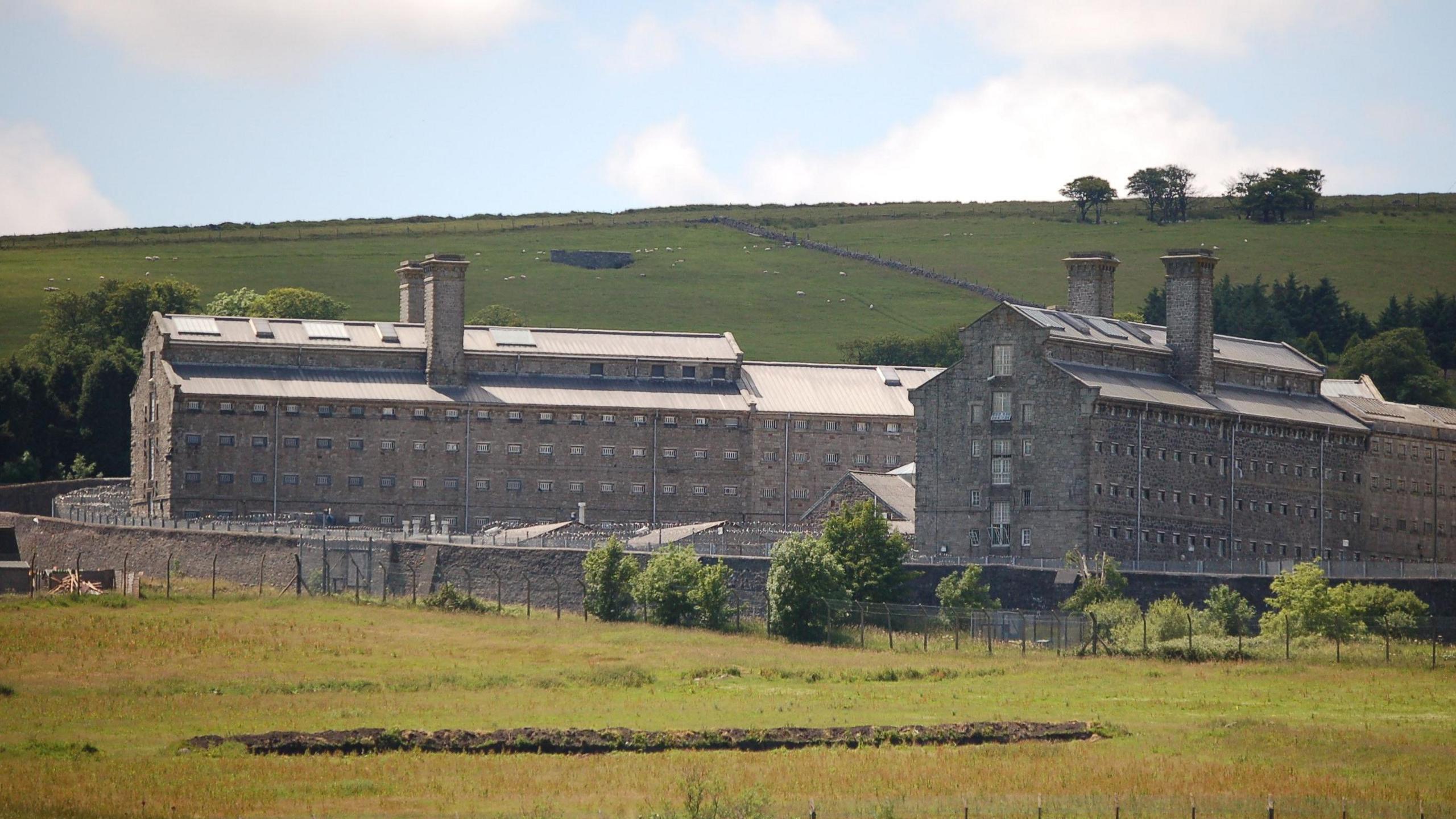 A view of Dartmoor Prison with green fields surrounding it