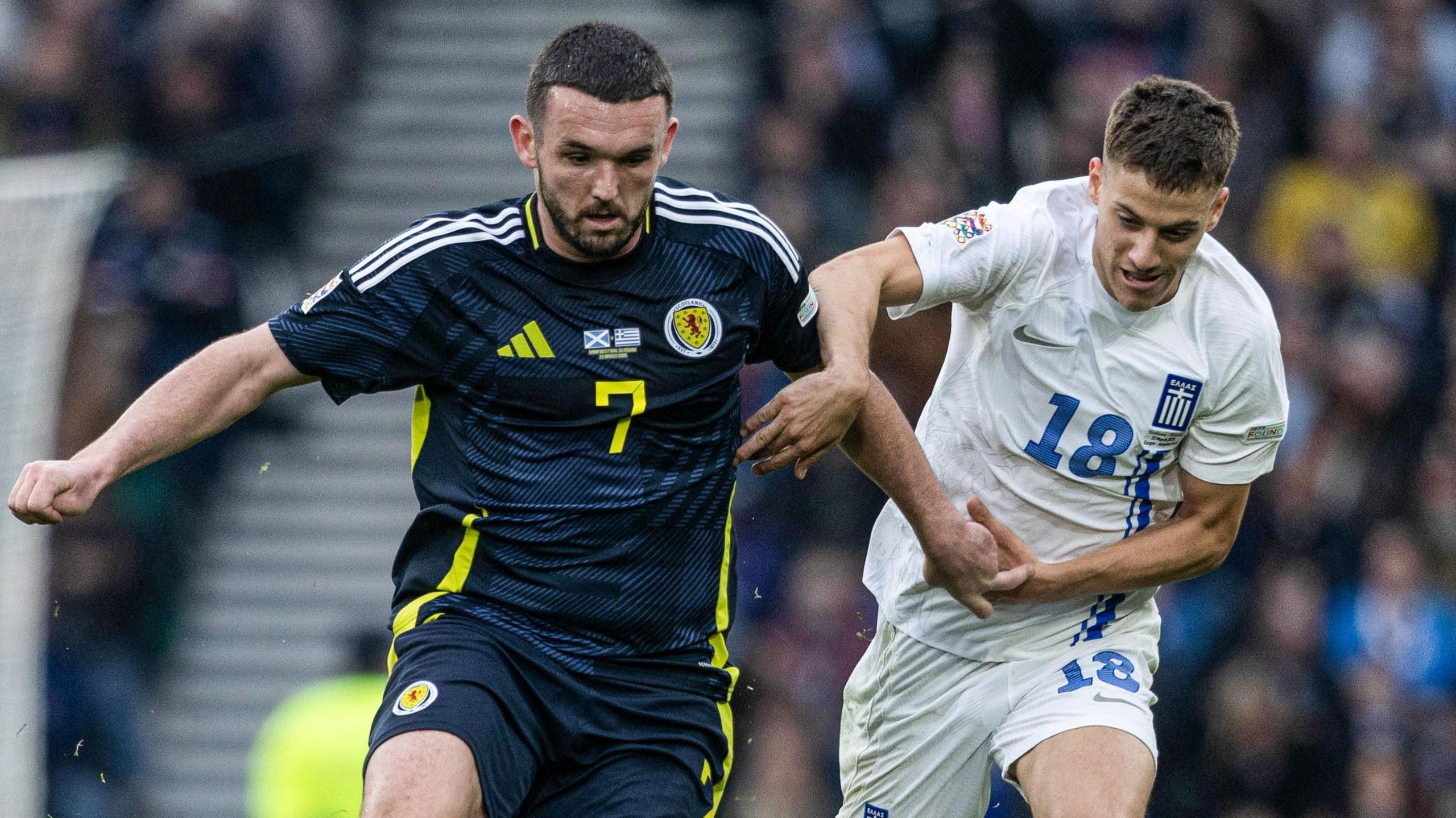 Scotland's John McGinn and Greece’s Giannis Konstantelias