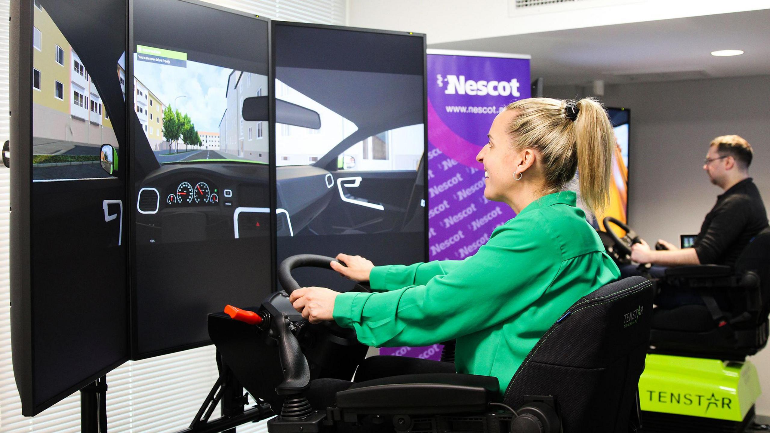 Two people on vehicle simulators