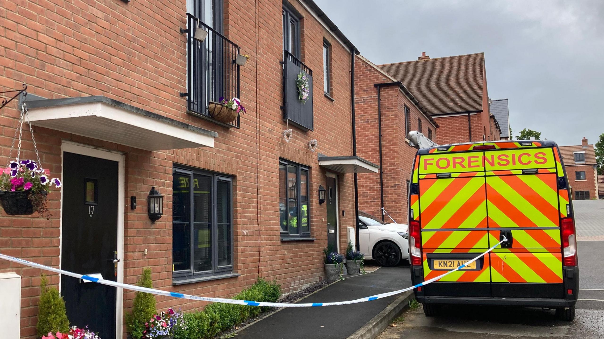 The cordon in place including a police forensics van