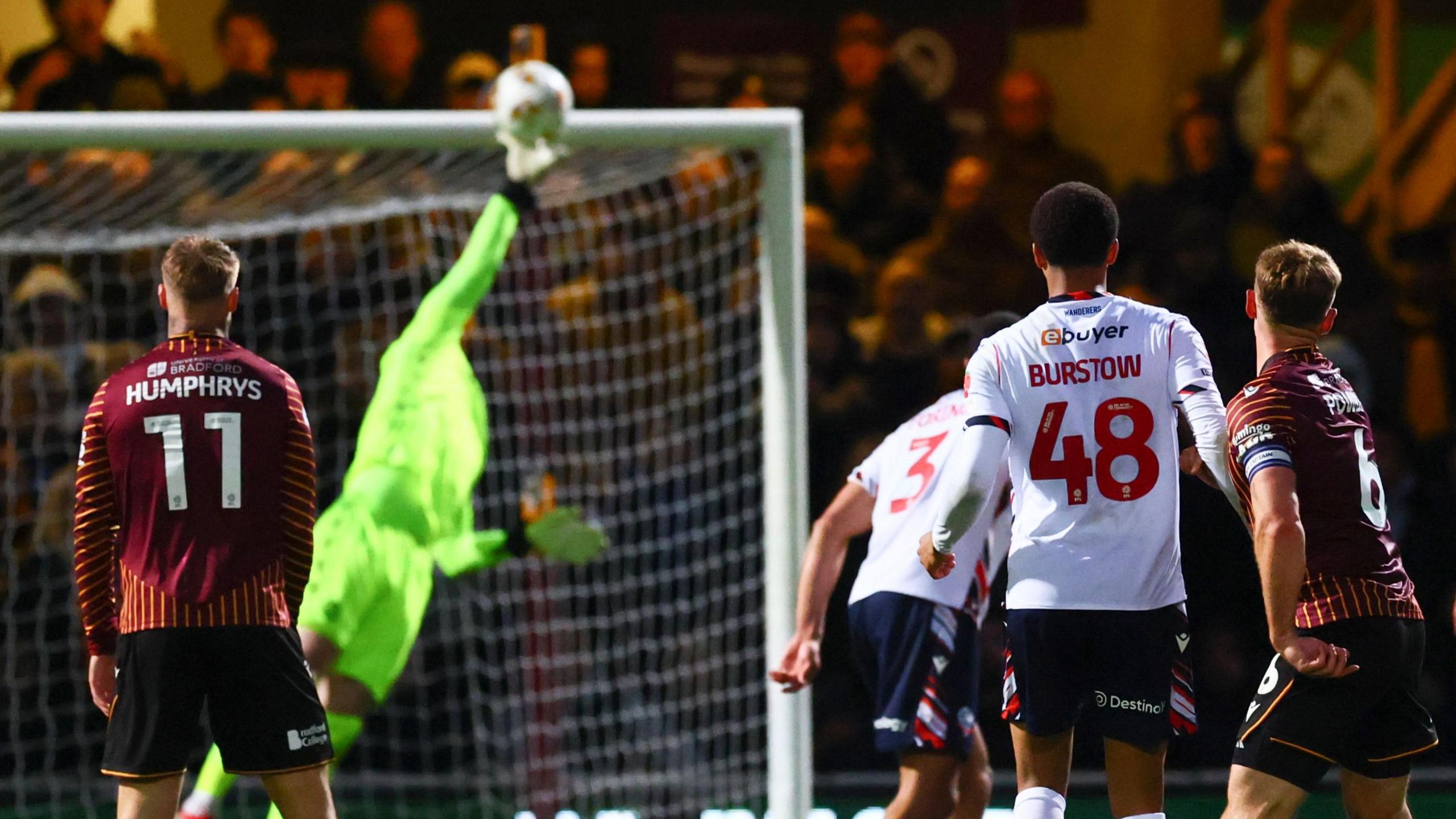 Bolton Wanderers goalkeeper Jack Bonham tips a shot from Bradford City's Max Power on to the bar