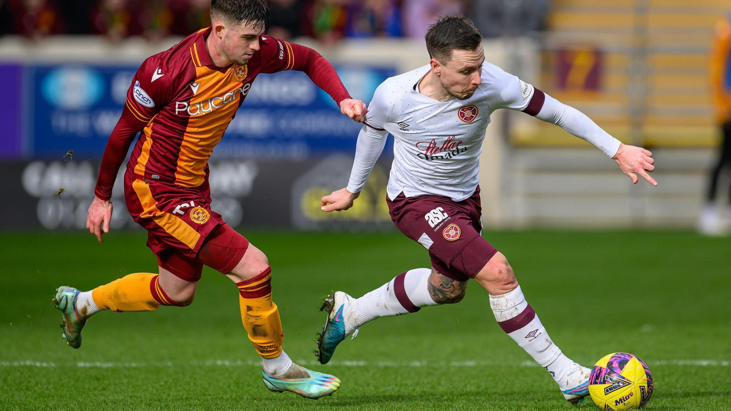 James Furlong in action for Motherwell, tugging the shirt of an opponent