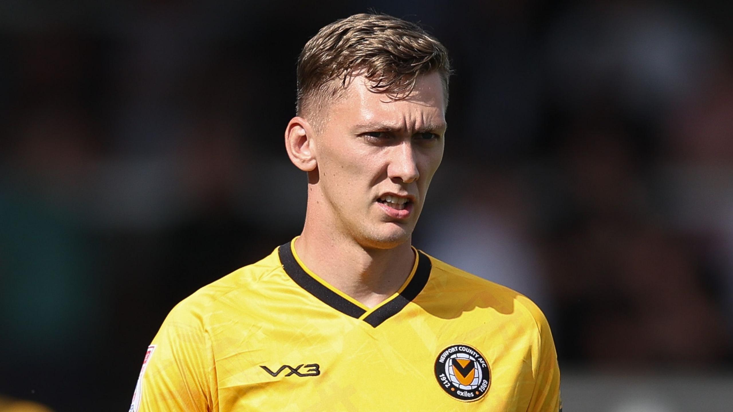 Newport County midfielder Nathan Wood looks on