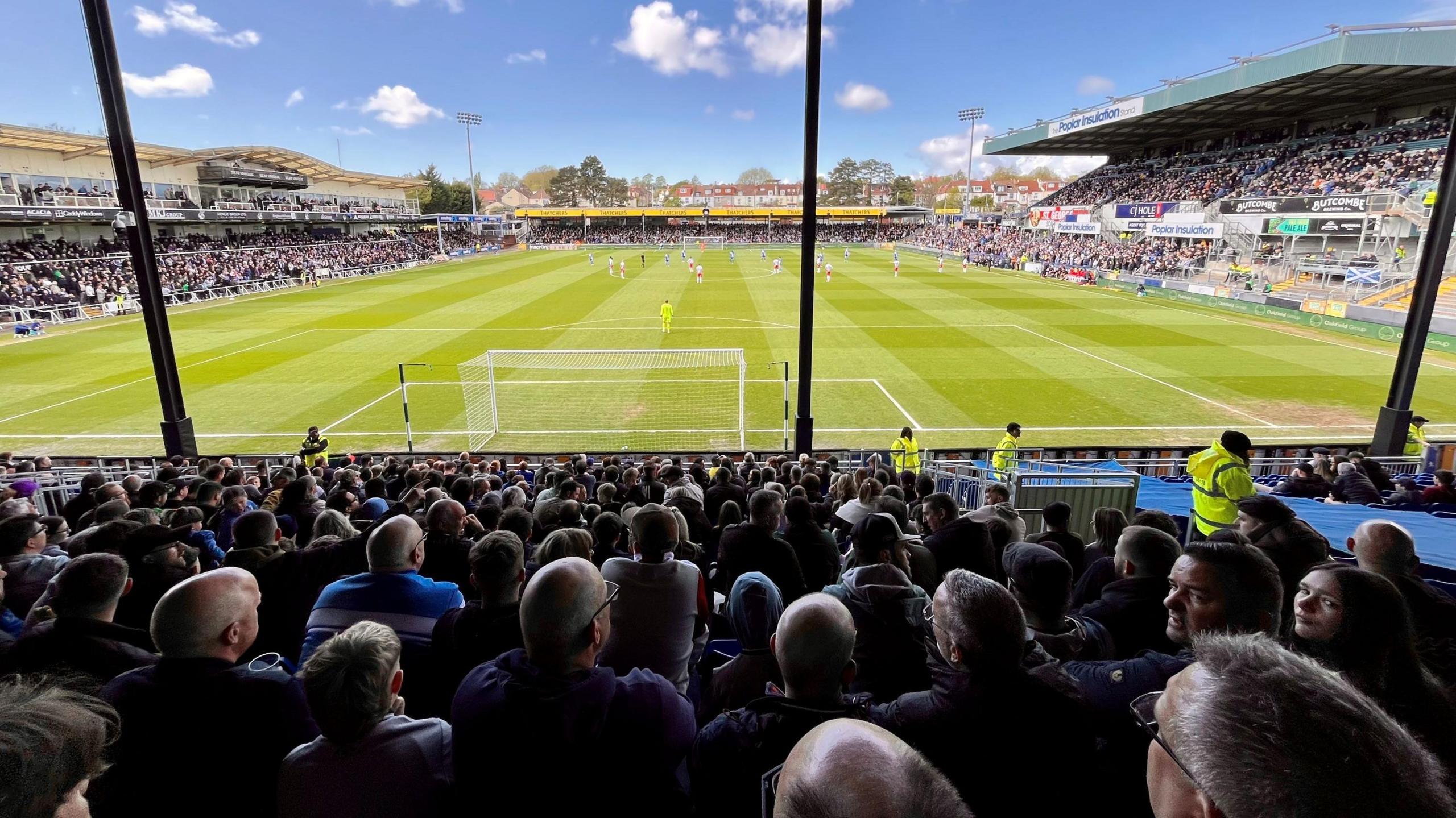 A view from the stands at the Memorial Stadium as Bristol Rovers play Stevenage on Easter Monday. The view is from the South Stand looking towards the Blackthorn Terrace. It is a sunny day and the stands are full