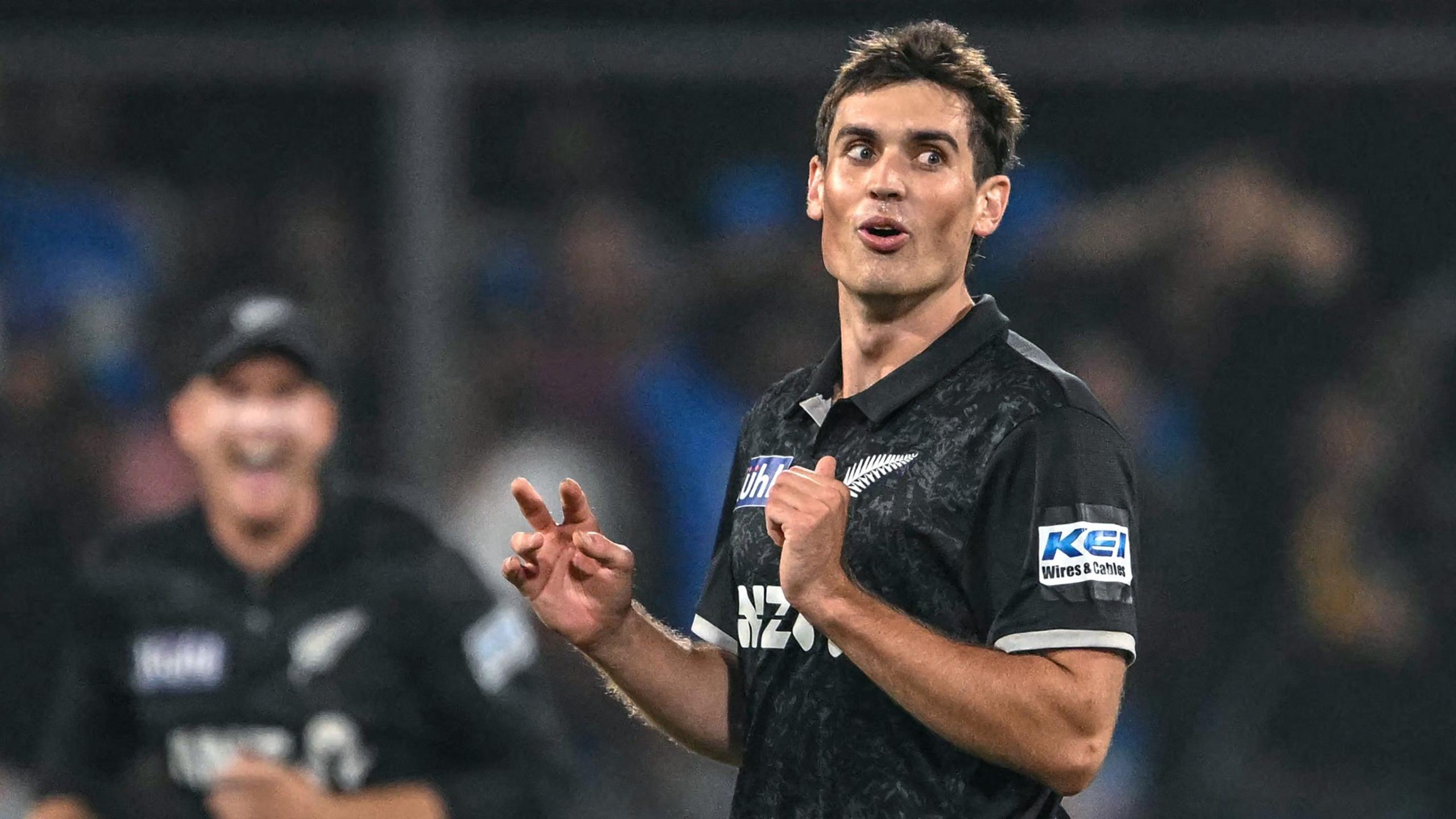 New Zealand fast bowler Kristian Clarke looks on during a one-day international cricket match with India, wearing a black shirt of his national team.