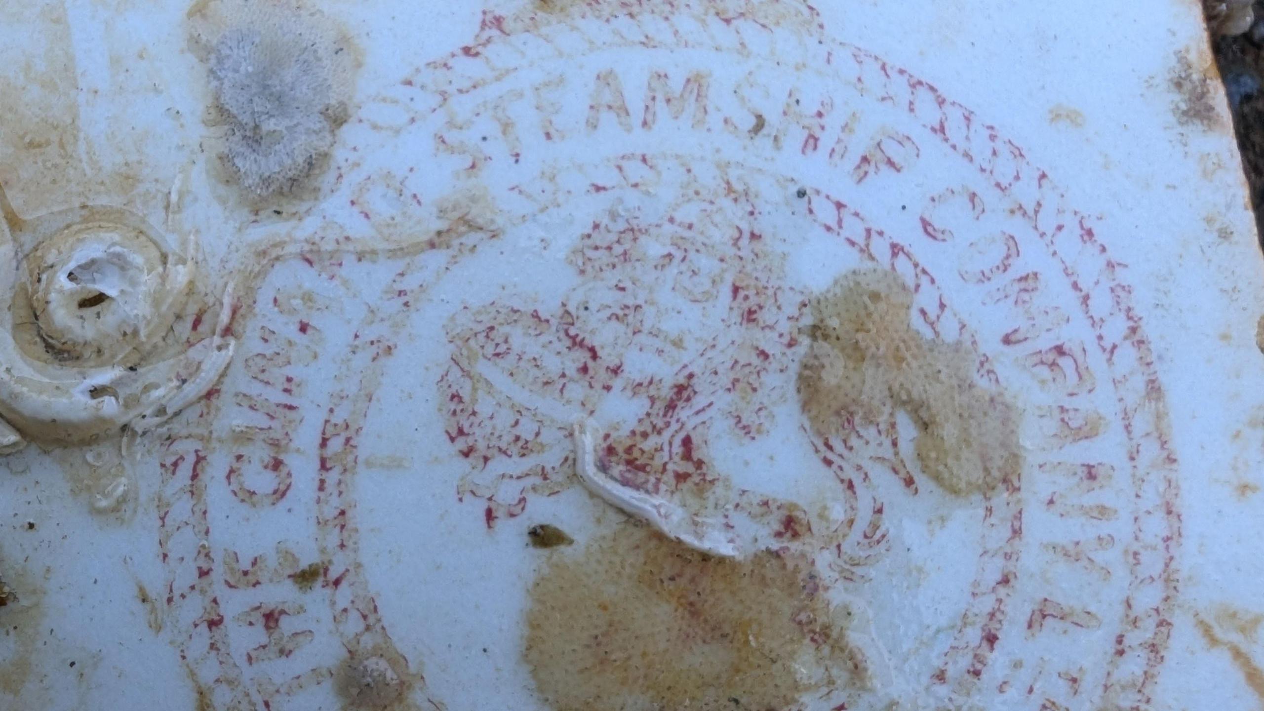 The plate found in the shipwreck with the Cunard logo
