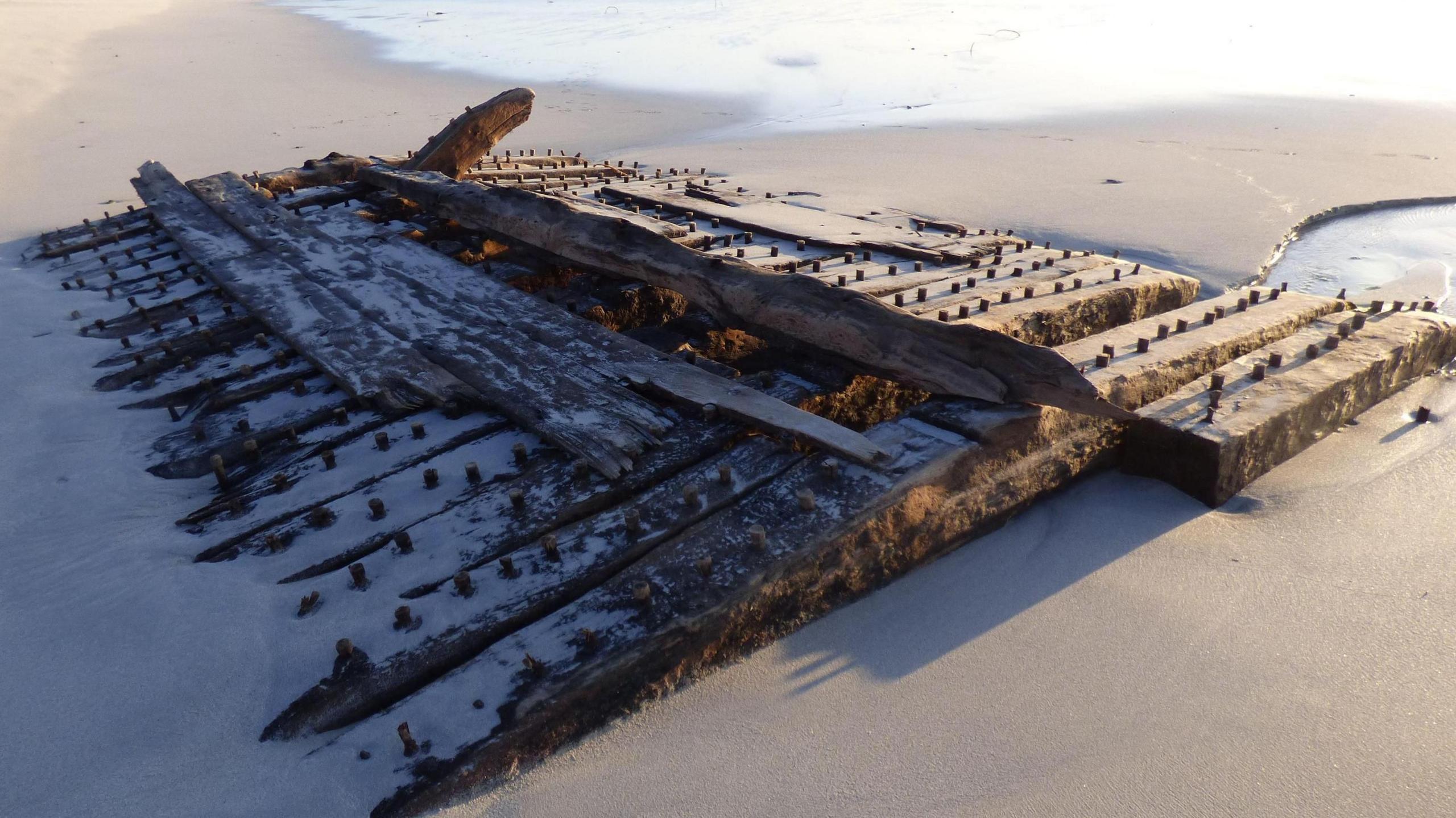 Wooden ship wreck on a beach