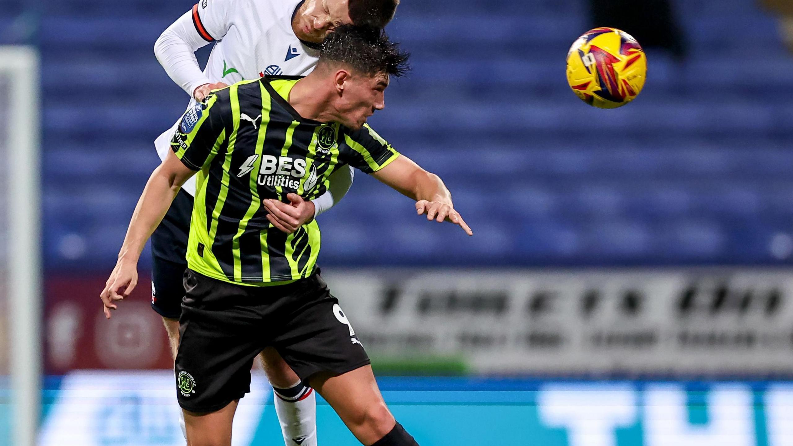 Fleetwood Town's Kian Harratt and Bolton Wanderers' Will Forrester contest a header during a match between the two clubs in November 