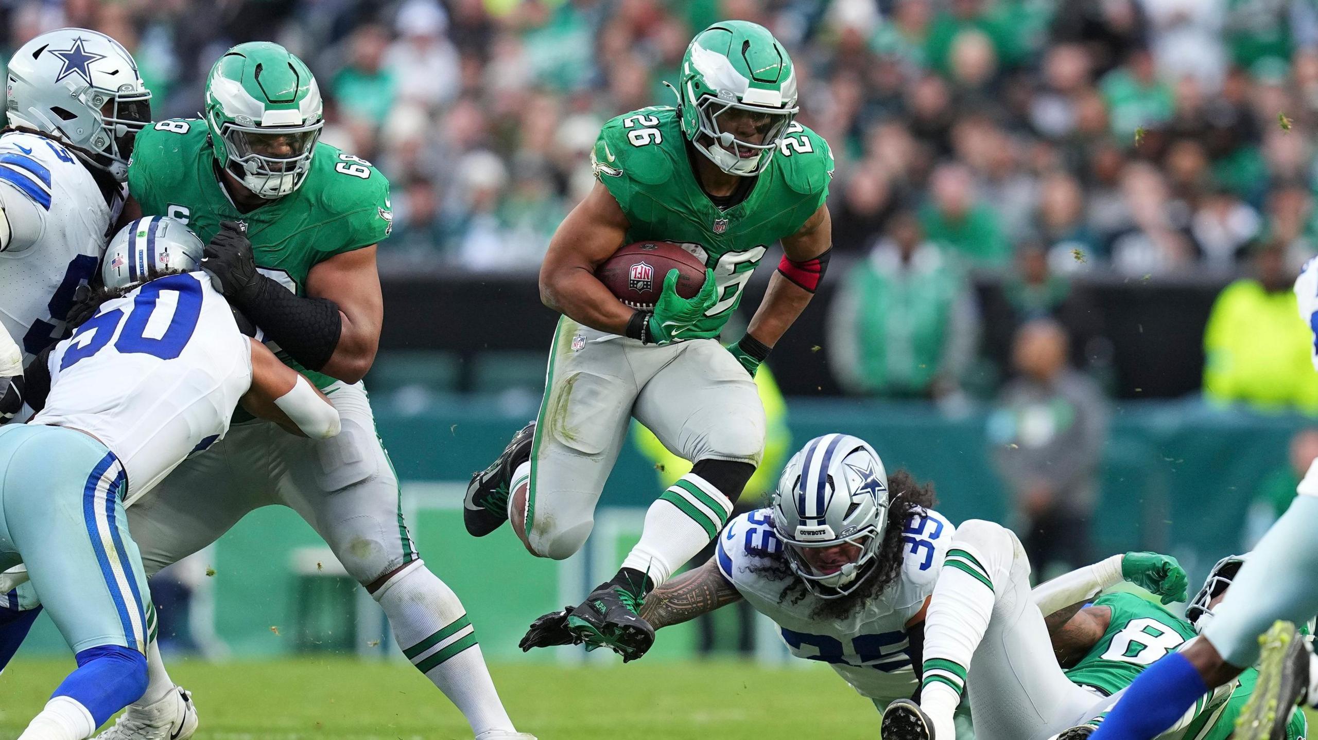 Eagles running back Saquon Barkley runs through some Dallas Cowboys defenders