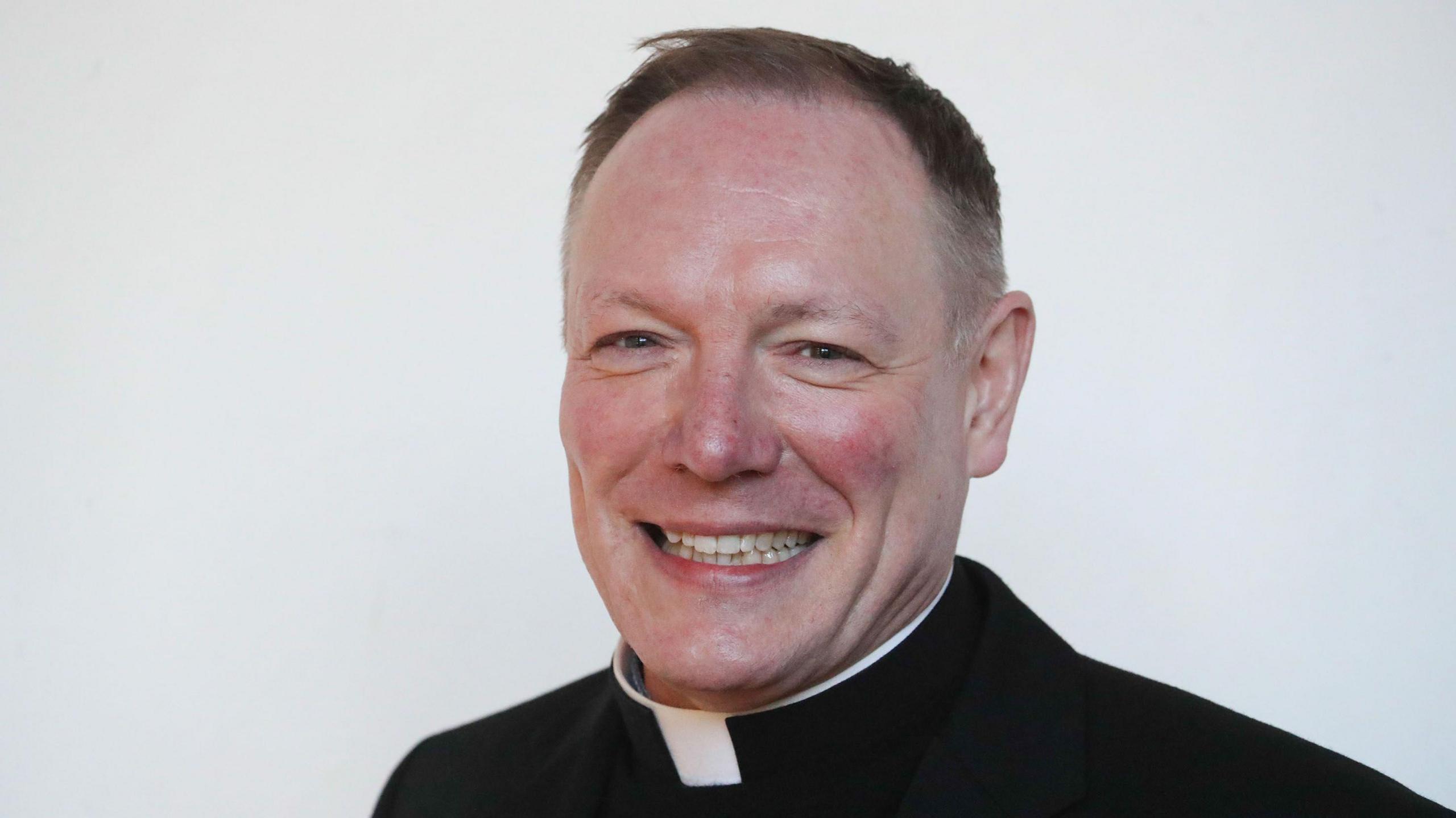 The Very Reverend Toby Wright, Dean of Wells. He is wearing a clerical robe and collar. 