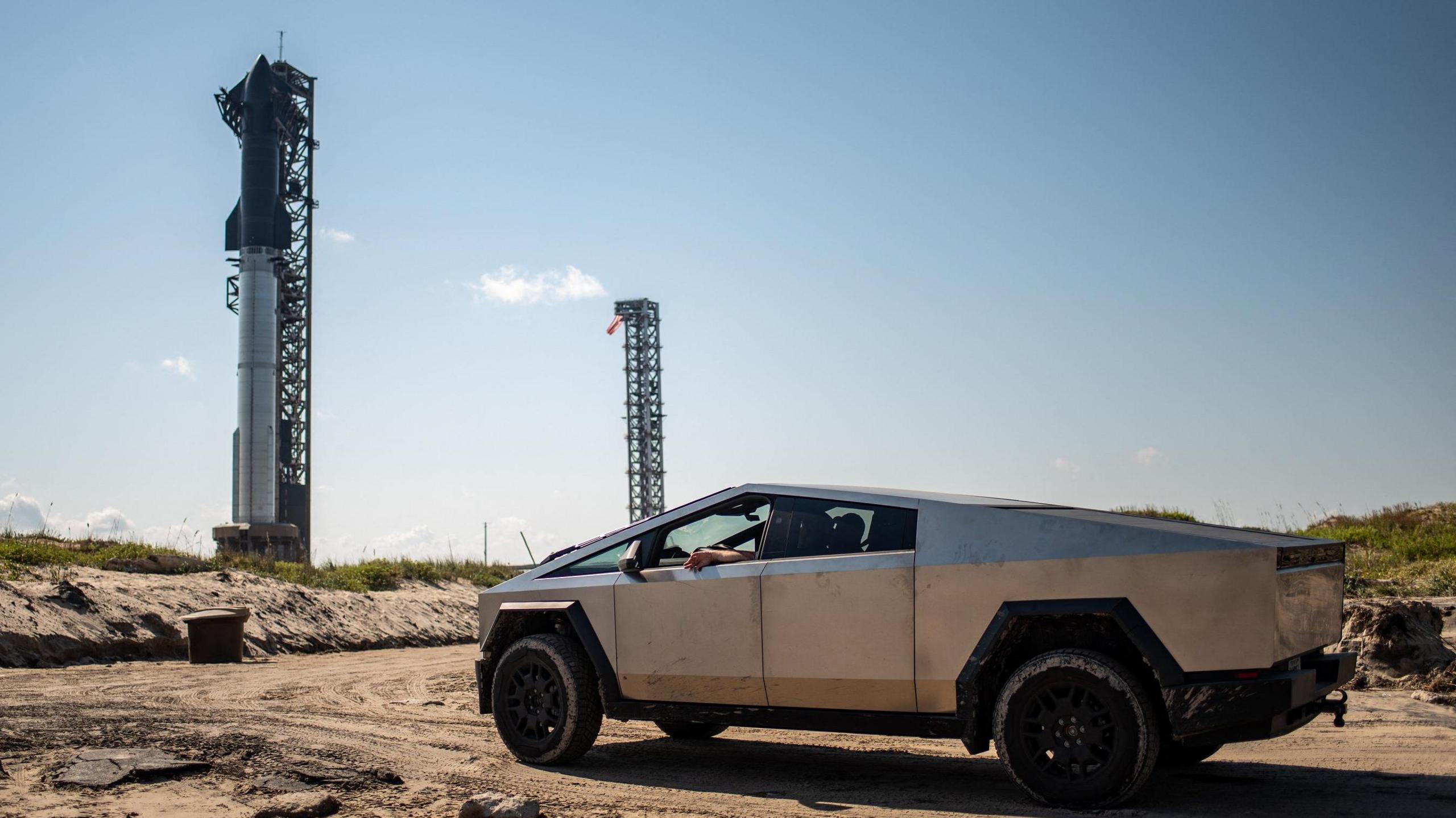 A Tesla Cybertruck faces the SpaceX Starship as it sits on a launch pad at Starbase near Boca Chica, Texas, on October 12, 2024, ahead of the Starship Flight 5 test. 