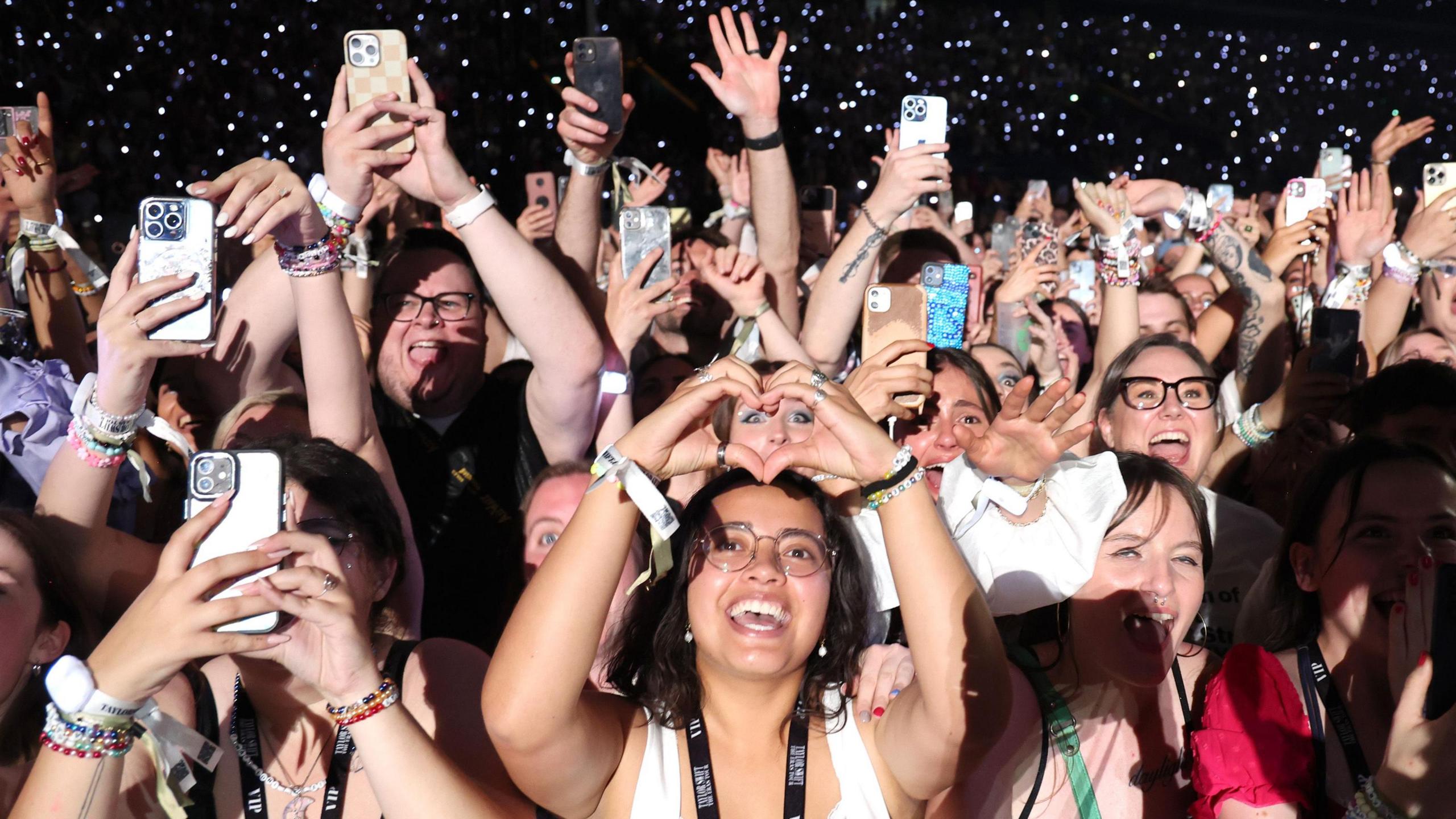  Fans watch Taylor Swift perform onstage during night two of "Taylor Swift | The Eras Tour" at La Defense on 10 May, 2024 in Paris, France.