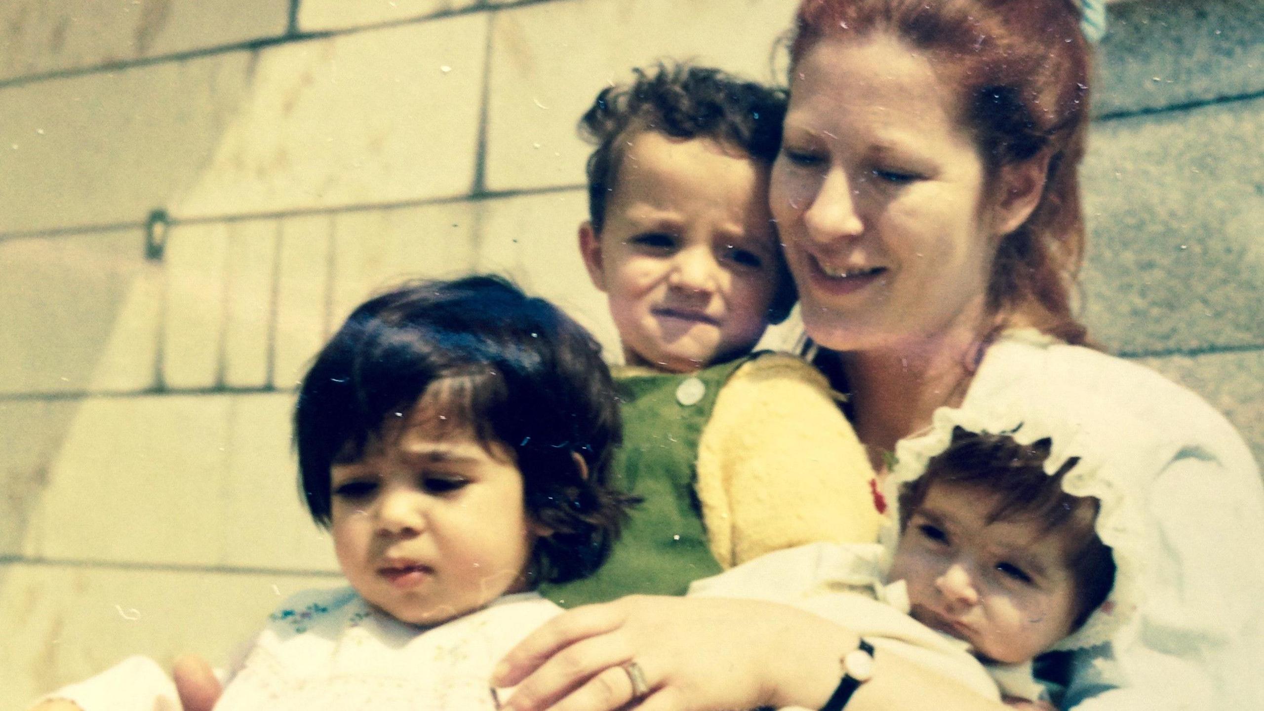 An Iranian adoptee who requested anonymity, bottom left, as a child.