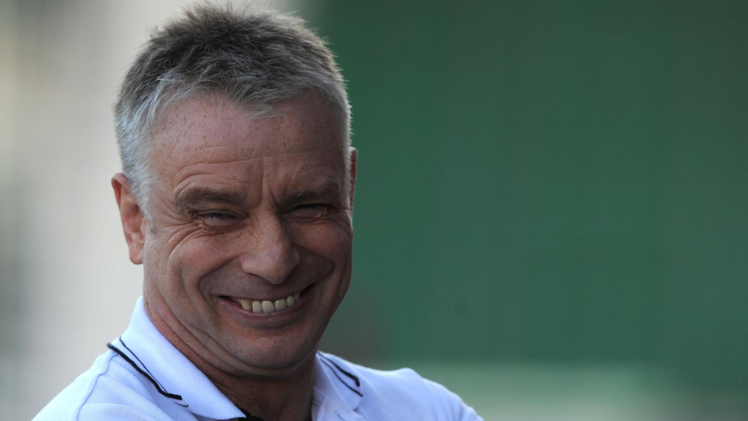 Brian Noble smiles during a training session