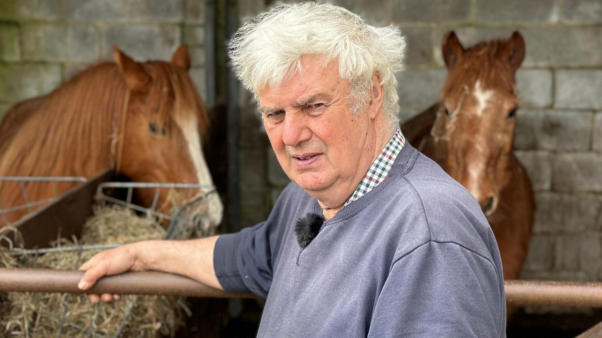 John Penny in front of two of his horses