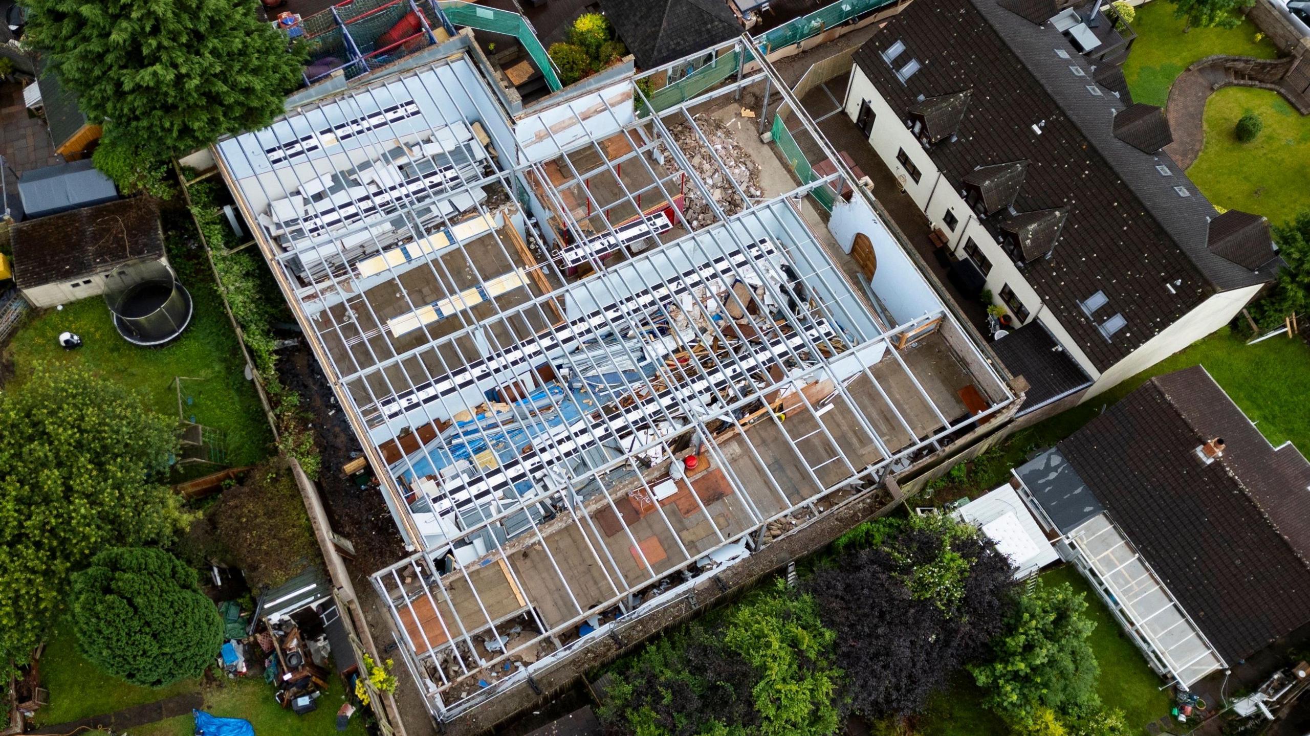 Aerial view of the man cave. The roof is missing, showing the foundations.  