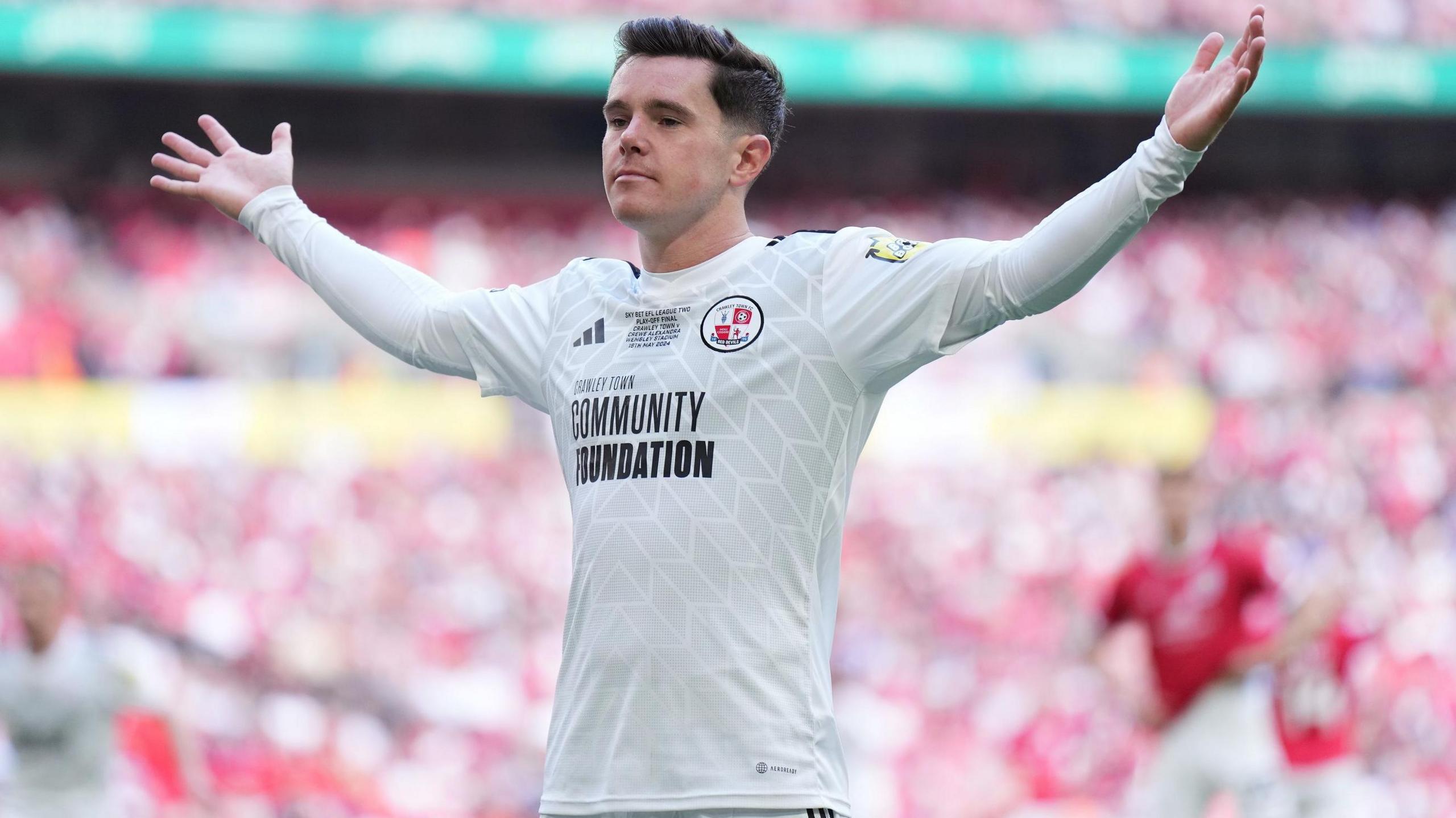 Liam Kelly celebrates scoring in front of the Crawley fans at Wembley