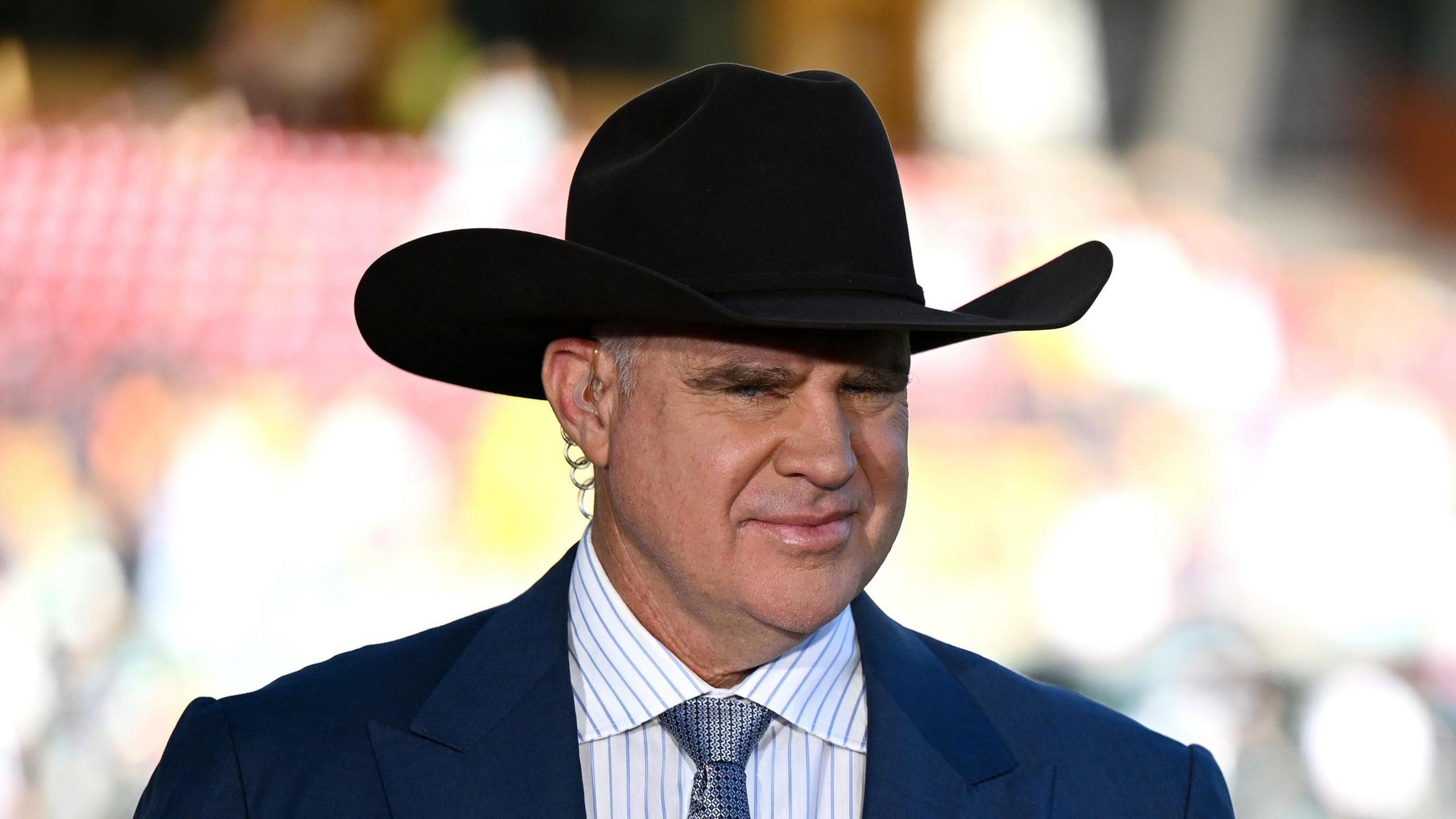 Matthew Hayden wearing a large hat while offering punditry on the Ashes