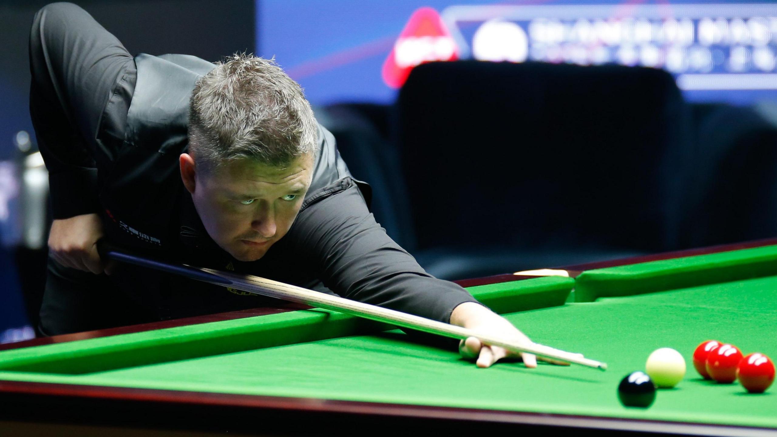 Kyren Wilson plays a shot