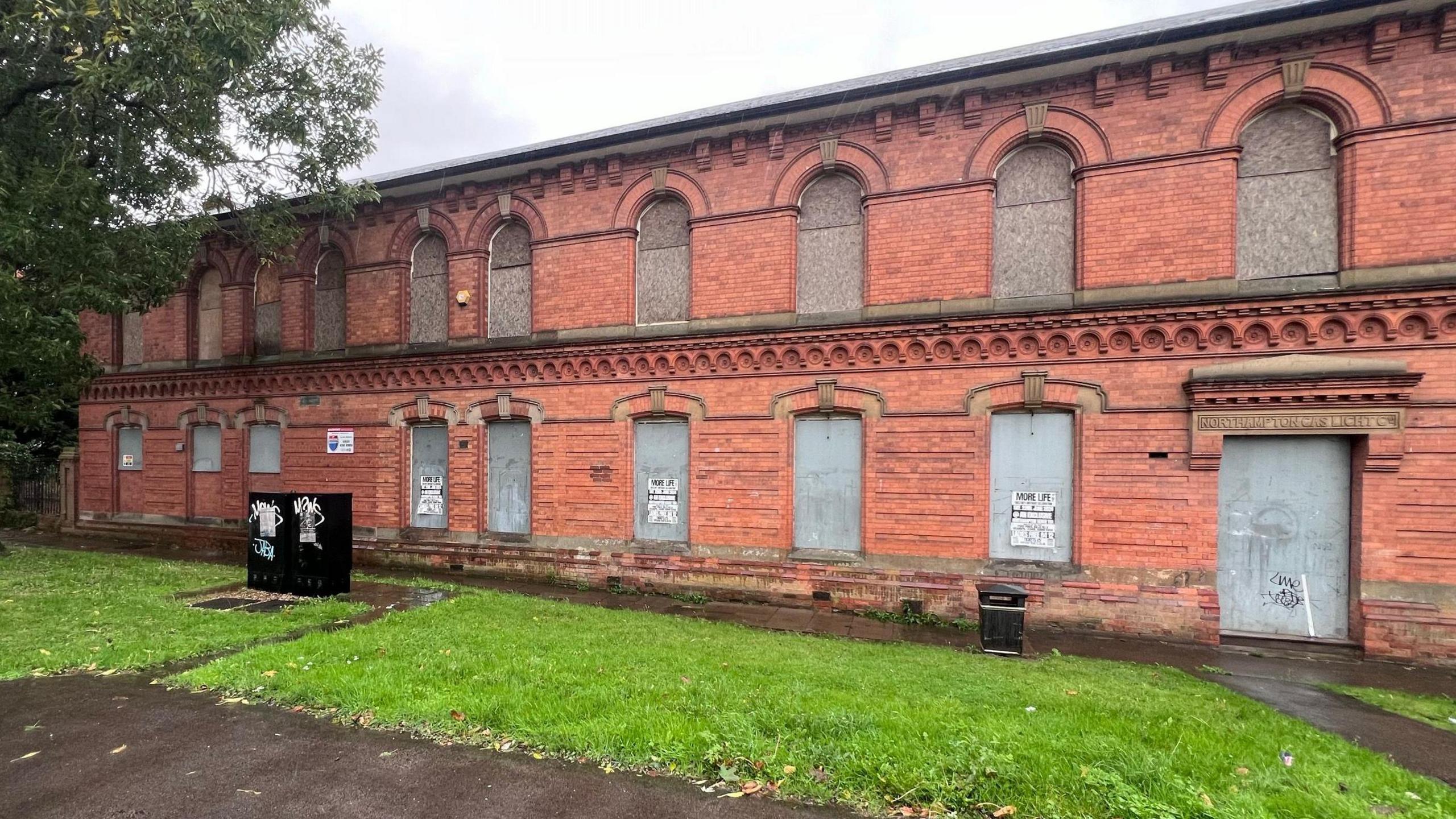 Former Northampton Gas Works building shown with boarded up windows