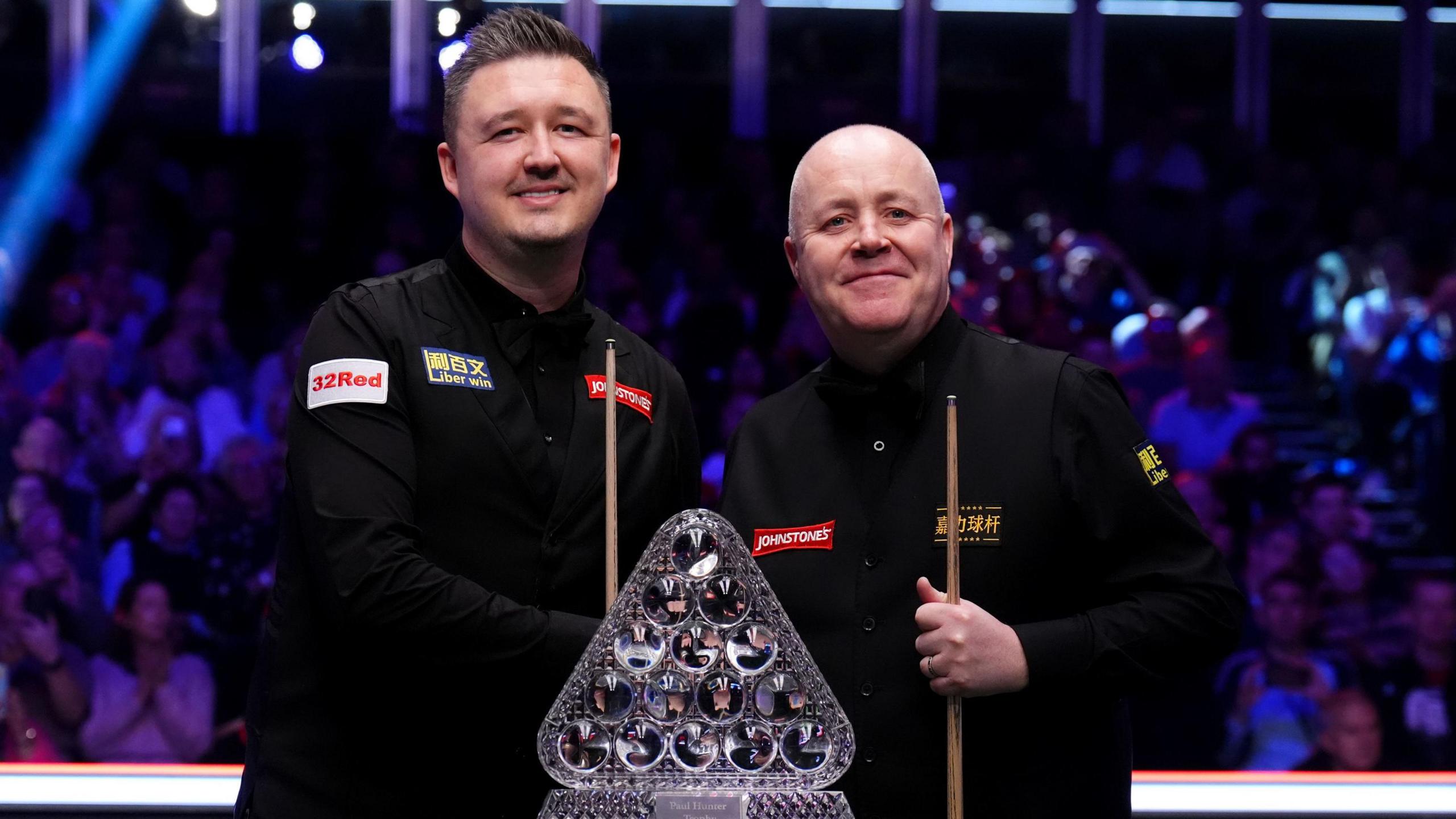Kyren Wilson and John Higgins pose with trophy